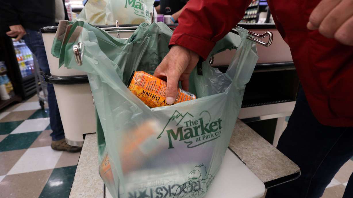 Riley War bags groceries at The Market at Park City in Park City on May 16, 2017. The state of Colorado will impose a 10-cent charge to use plastic or paper bags at stores beginning in 2023.