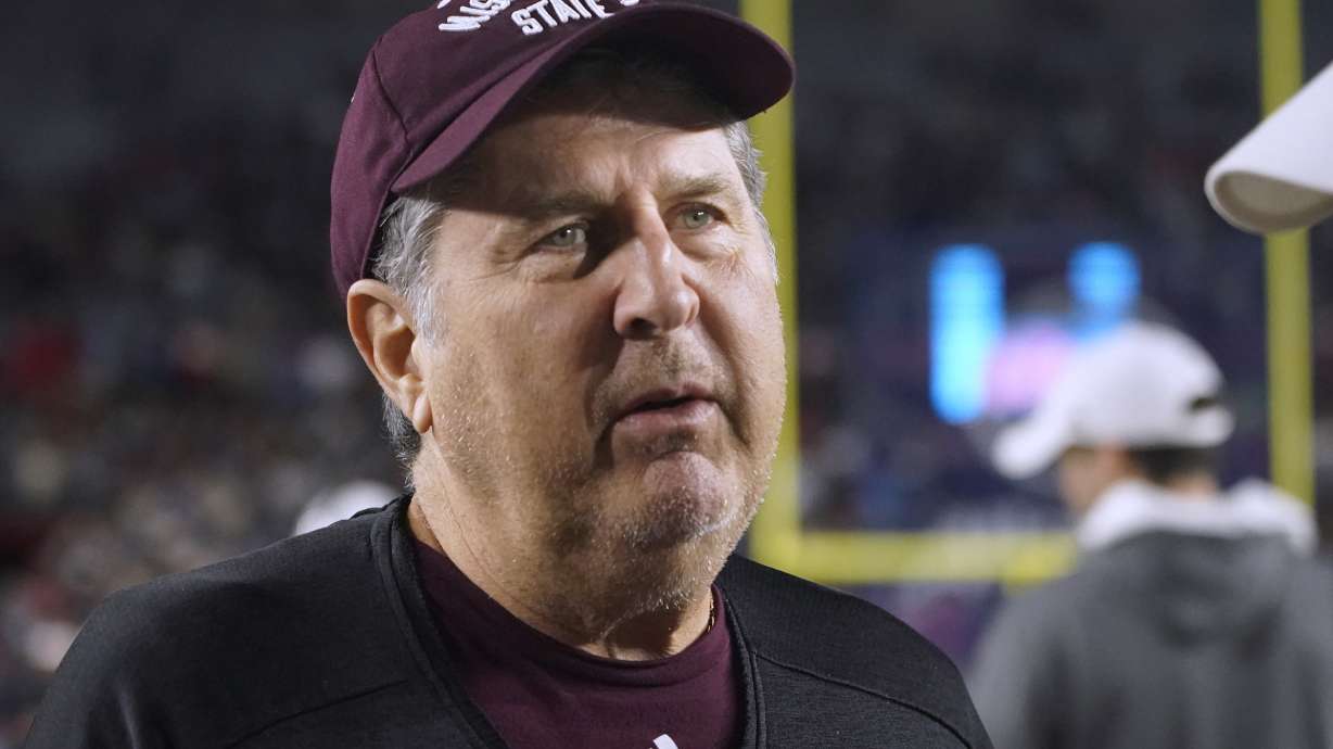 Mississippi State coach Mike Leach talks with Mississippi coach Lane Kiffin before an NCAA college football game in Oxford, Miss., Nov. 24. Leach has died following complications from a heart condition at the age of 61.