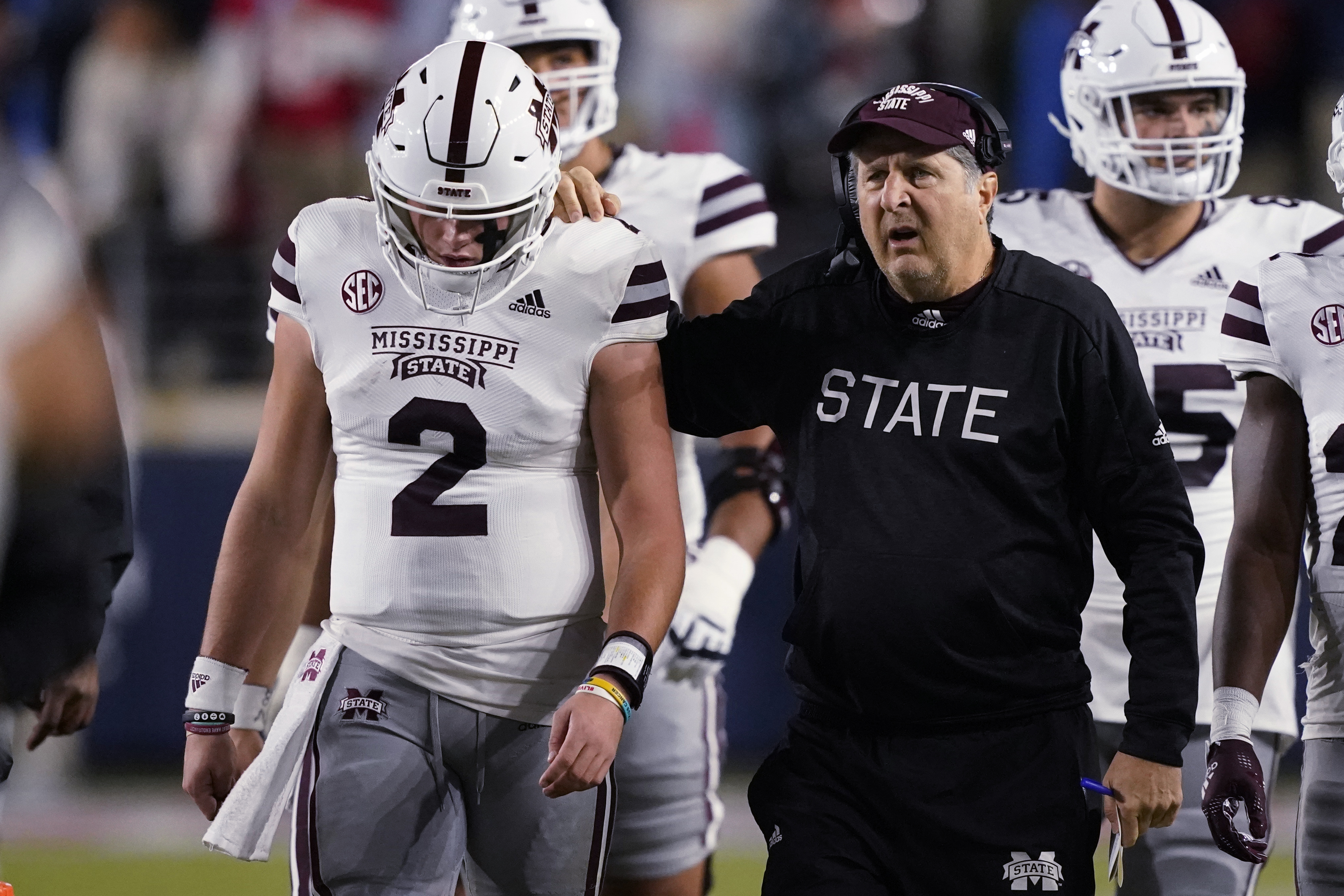 Mississippi State coach Mike Leach confers with quarterback Will Rogers (2) during the first half of the team's NCAA college football game against Mississippi in Oxford, Miss., Nov. 24.