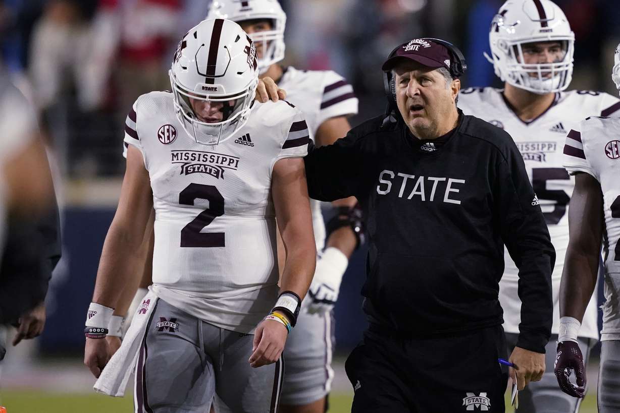 Mississippi State coach Mike Leach confers with quarterback Will Rogers (2) during the first half of the team's NCAA college football game against Mississippi in Oxford, Miss., Nov. 24.