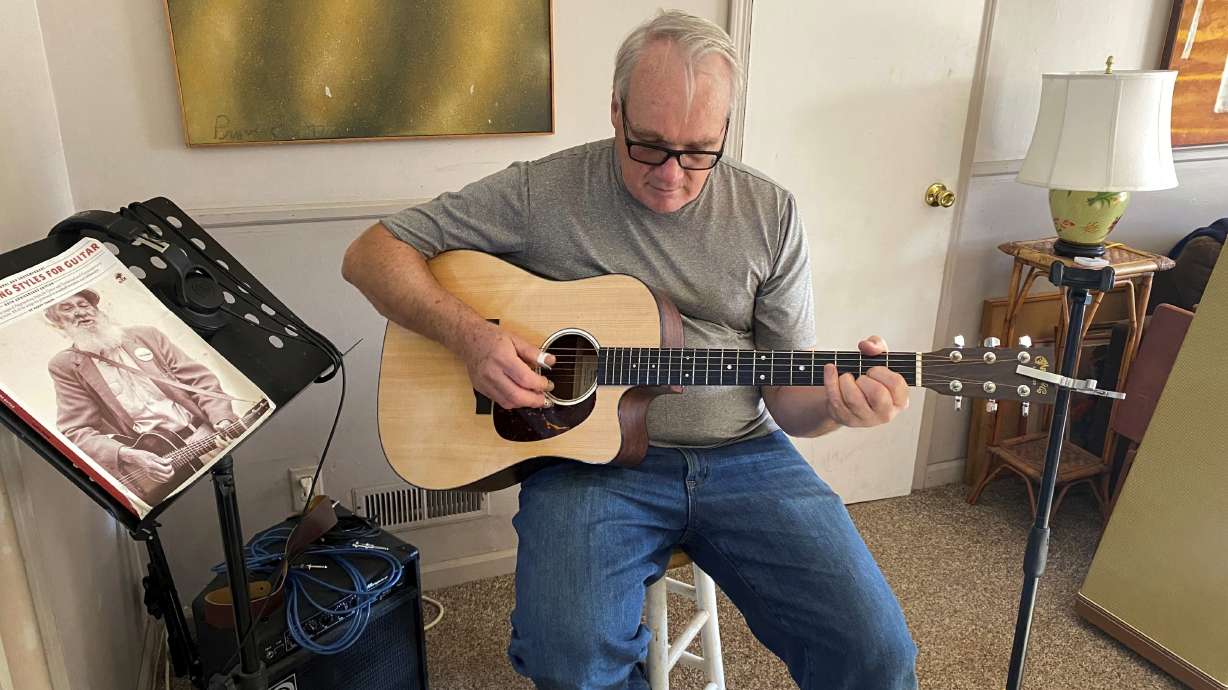 Bob Dorobis plays his guitar at home in Middletown, N.J., on Dec. 4. Dorobis redoubled his efforts to learn fingerpicking during the pandemic.