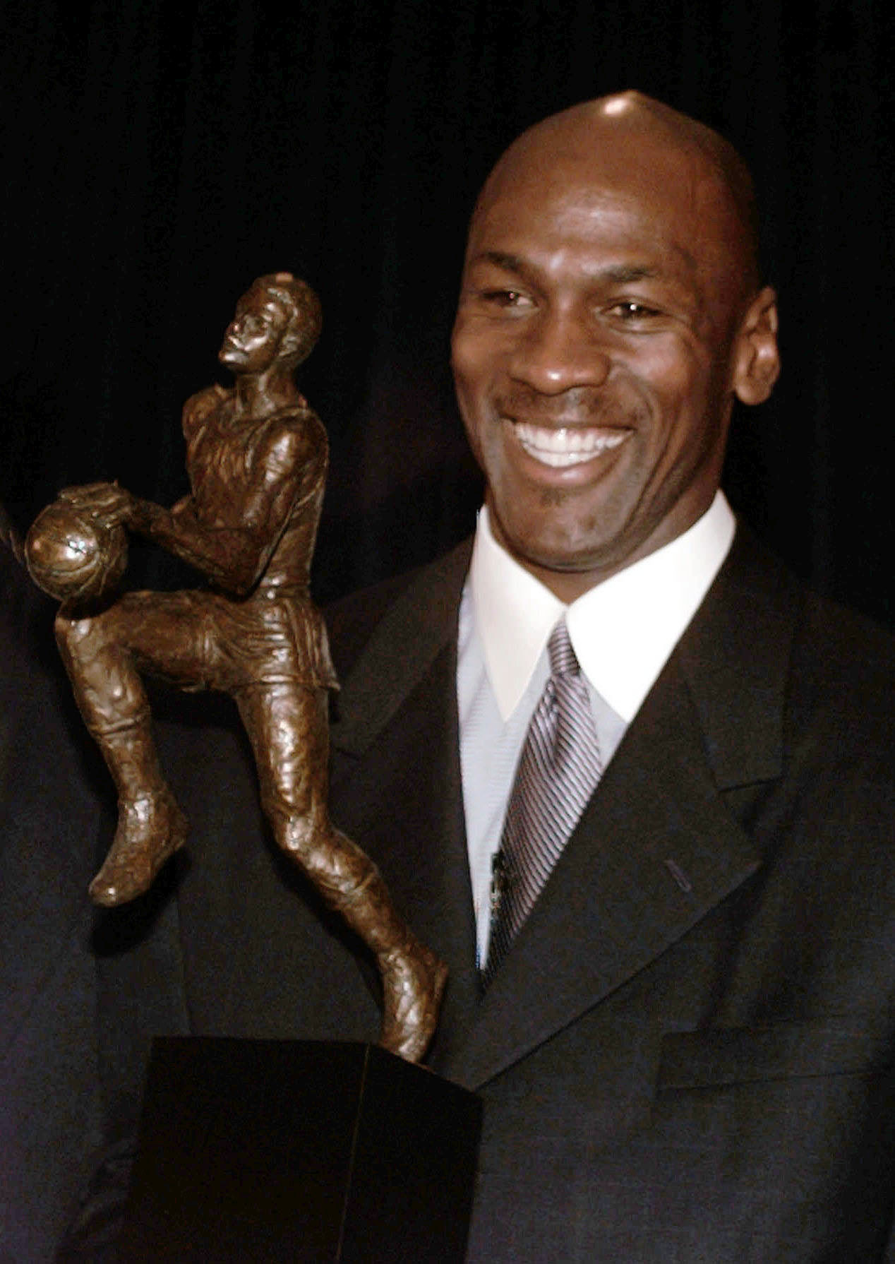 FILE - Chicago Bulls' Michael Jordan holds the Maurice Podoloff Trophy awarded to the NBA basketball Most Valuable Player for the 1995-96 season in Northbrook, Ill., May 20, 1996. The trophy carried Podoloff's name for about 60 years, and has now been reimagined and renamed for Jordan. 
