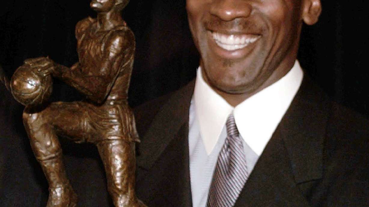 FILE - Chicago Bulls' Michael Jordan holds the Maurice Podoloff Trophy awarded to the NBA basketball Most Valuable Player for the 1995-96 season in Northbrook, Ill., May 20, 1996. The trophy carried Podoloff's name for about 60 years, and has now been reimagined and renamed for Jordan.
