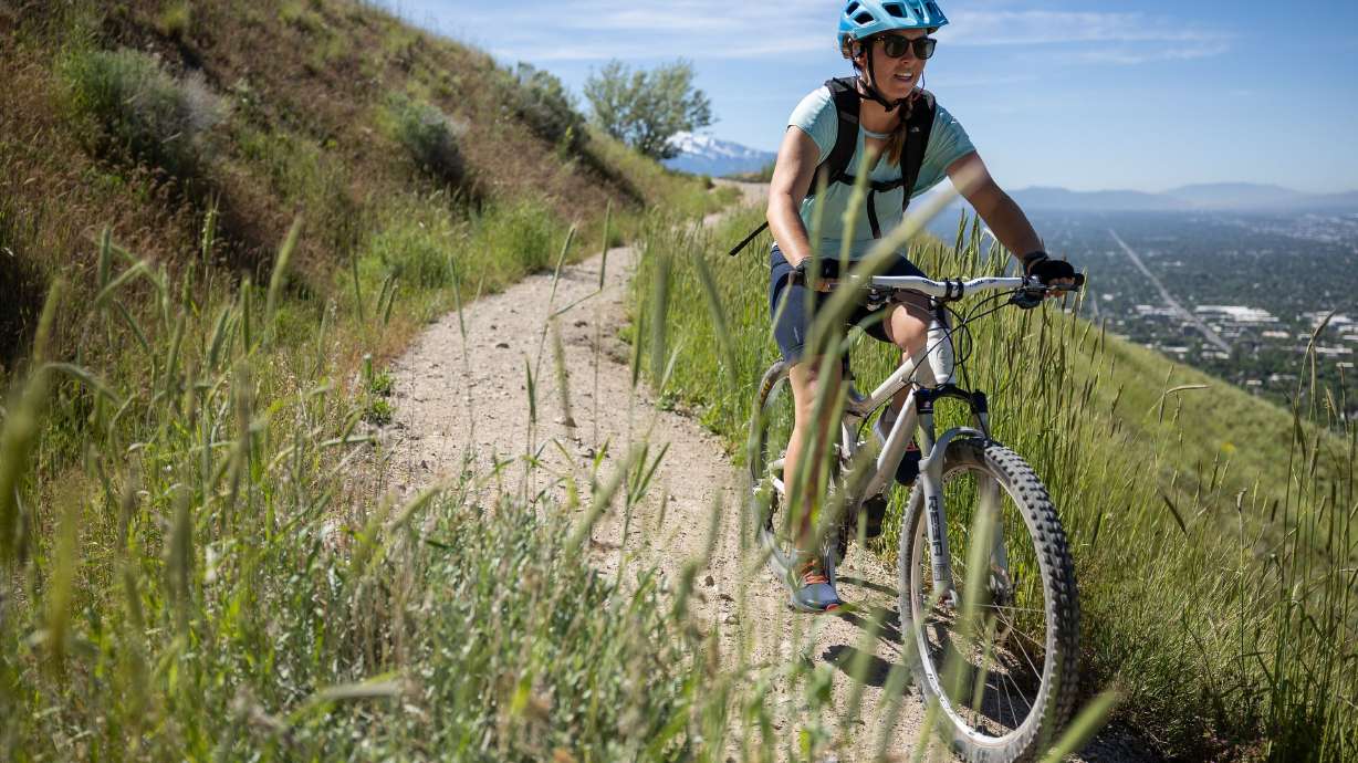 A cyclist on the Bonneville Shoreline Trail above Salt Lake City on June 2, 2022. Salt Lake City leaders agreed on Tuesday to use a new zone development process and unlock frozen funds to help develop new trails in the foothills.
