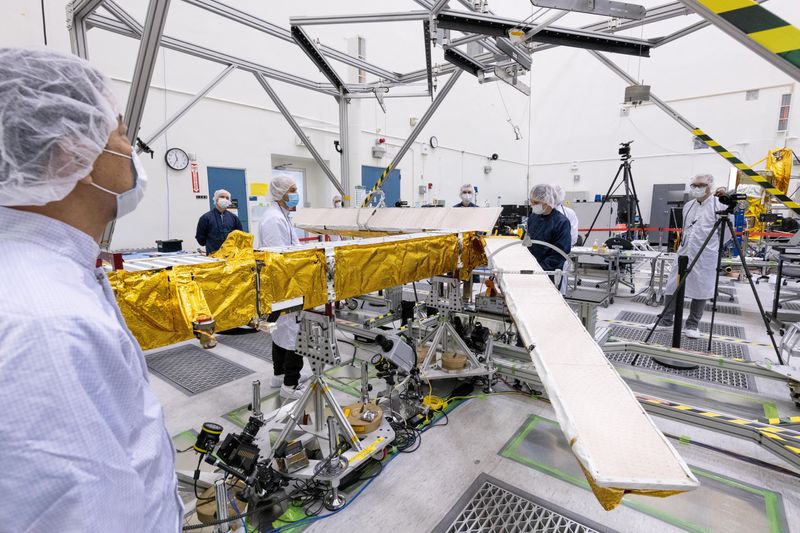 Members of the international Surface Water and Ocean Topography radar satellite mission test one of the antennas for the Ka-band Radar Interferometer instrument in a clean room at NASA's Jet Propulsion Laboratory in Pasadena, California in 2022.    