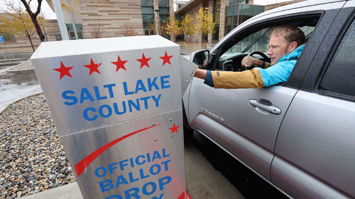 Guy Evans casts his mail in ballot in Cottonwood Heights on Nov. 8.