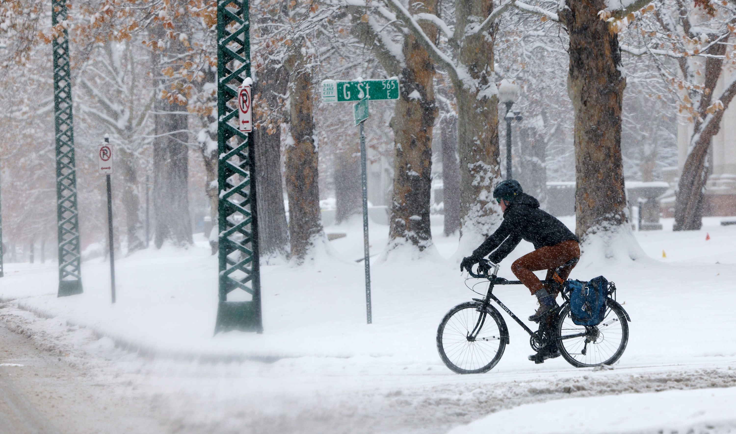 A cyclist rides on the street as snow falls in Salt Lake City on Tuesday.