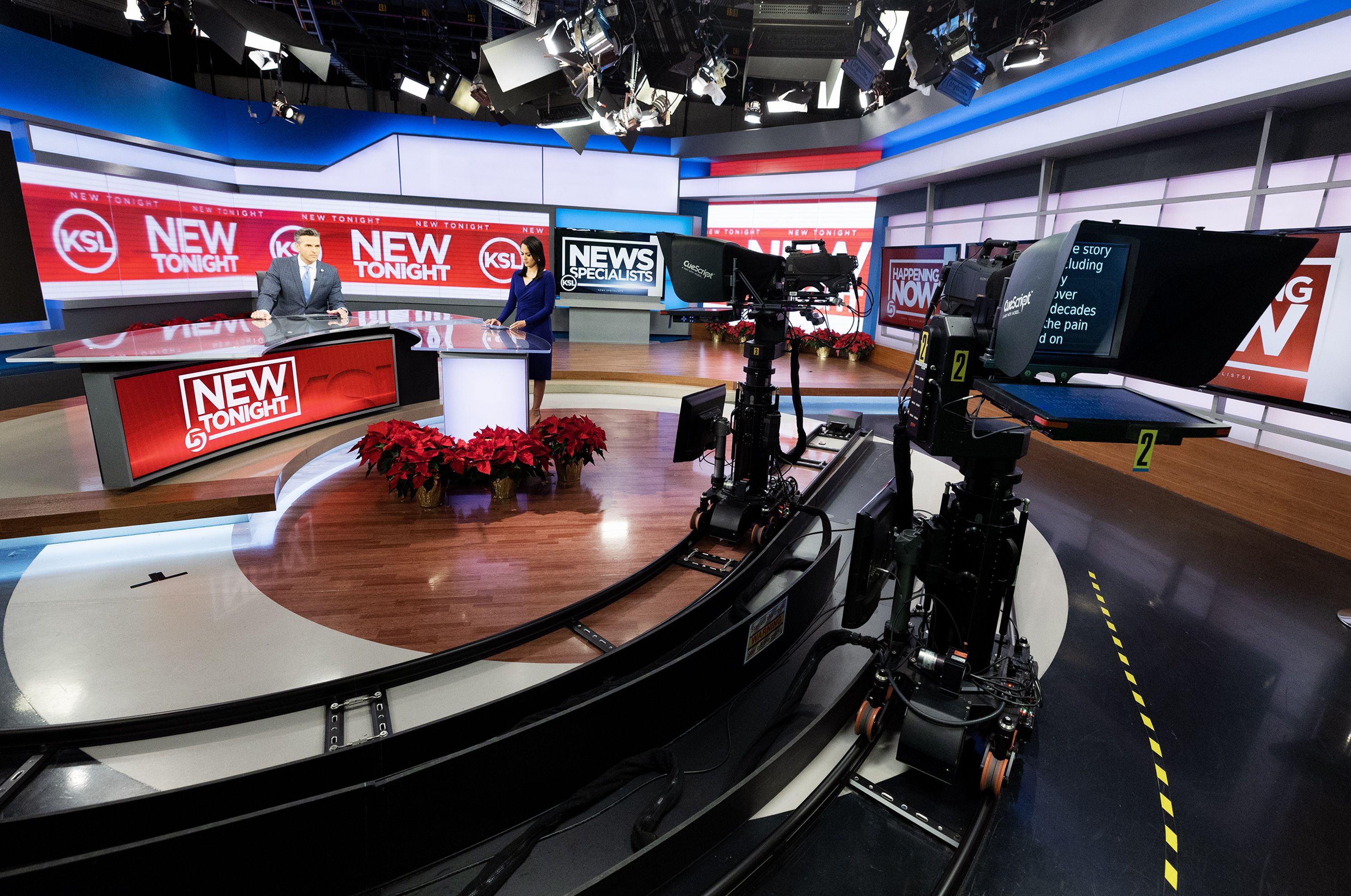 Ashley Moser and Mike Headrick present the news from the Triad Center in Salt Lake City on Dec. 6.