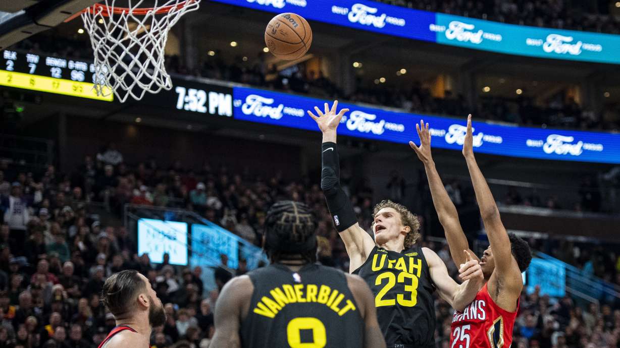 Utah Jazz forward Lauri Markkanen (23) lays the ball up while contested by New Orleans Pelicans guard Trey Murphy III (25) in the first half during an NBA basketball game Tuesday, Dec. 13, 2022, in Salt Lake City.