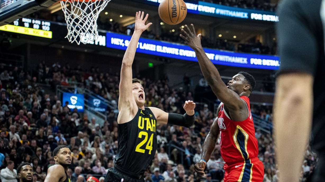 Utah Jazz center Walker Kessler (24) blocks a shot from New Orleans Pelicans forward Zion Williamson, right, in the second half during an NBA basketball game Tuesday, Dec. 13, 2022, in Salt Lake City.