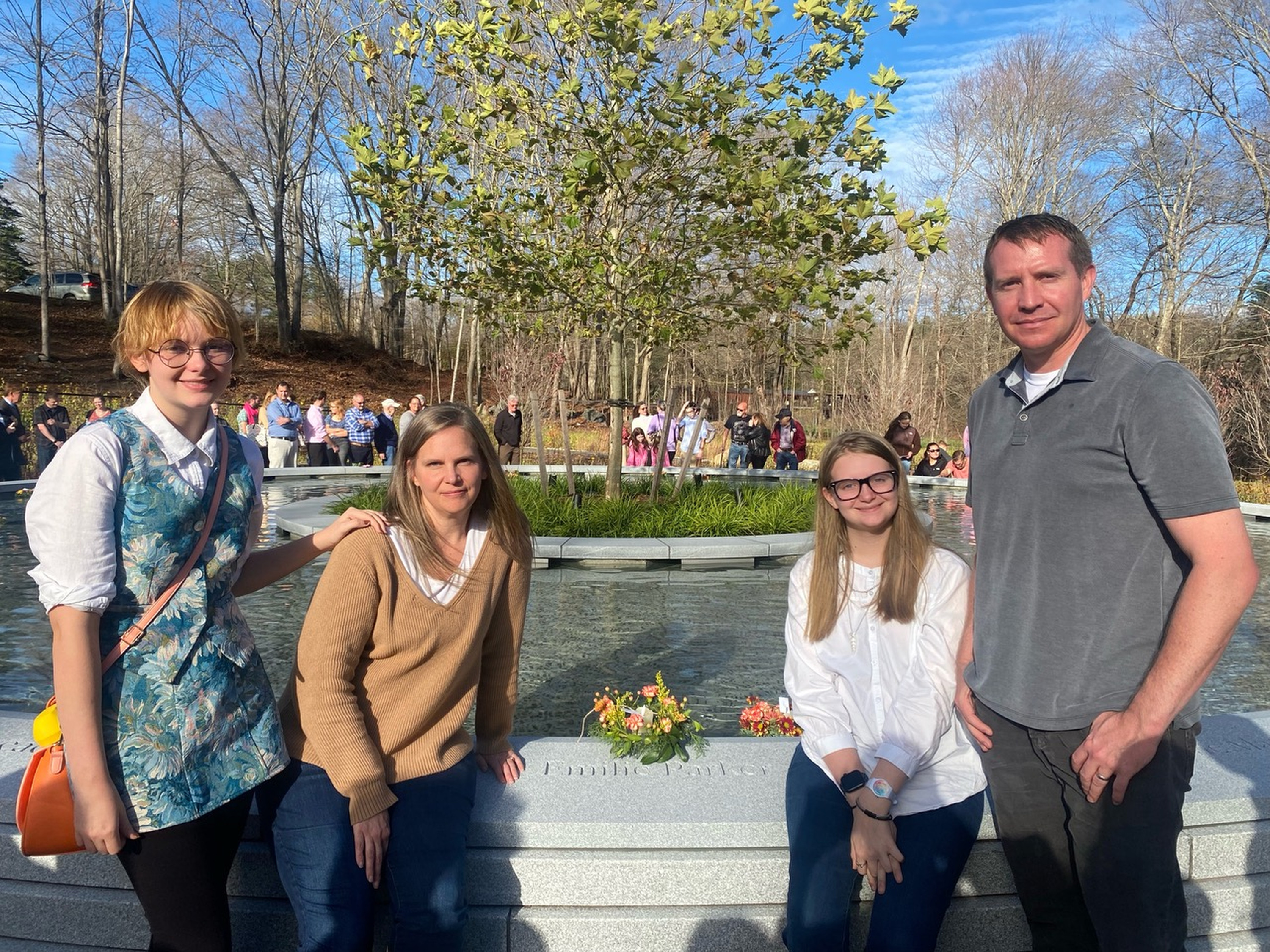 The Parker family at the Nov. 12, 2022, dedication of a memorial to Sandy Hook Elementary School shooting victims in Newtown, Connecticut. From left, Madeline, Alissa, Samantha and Robbie Parker surround the name of their daughter, Emilie, who was 6 when she was killed. In the decade since Emilie was taken from them, the Parkers say they’ve grieved, grown and learned to help others suffering terrible times.