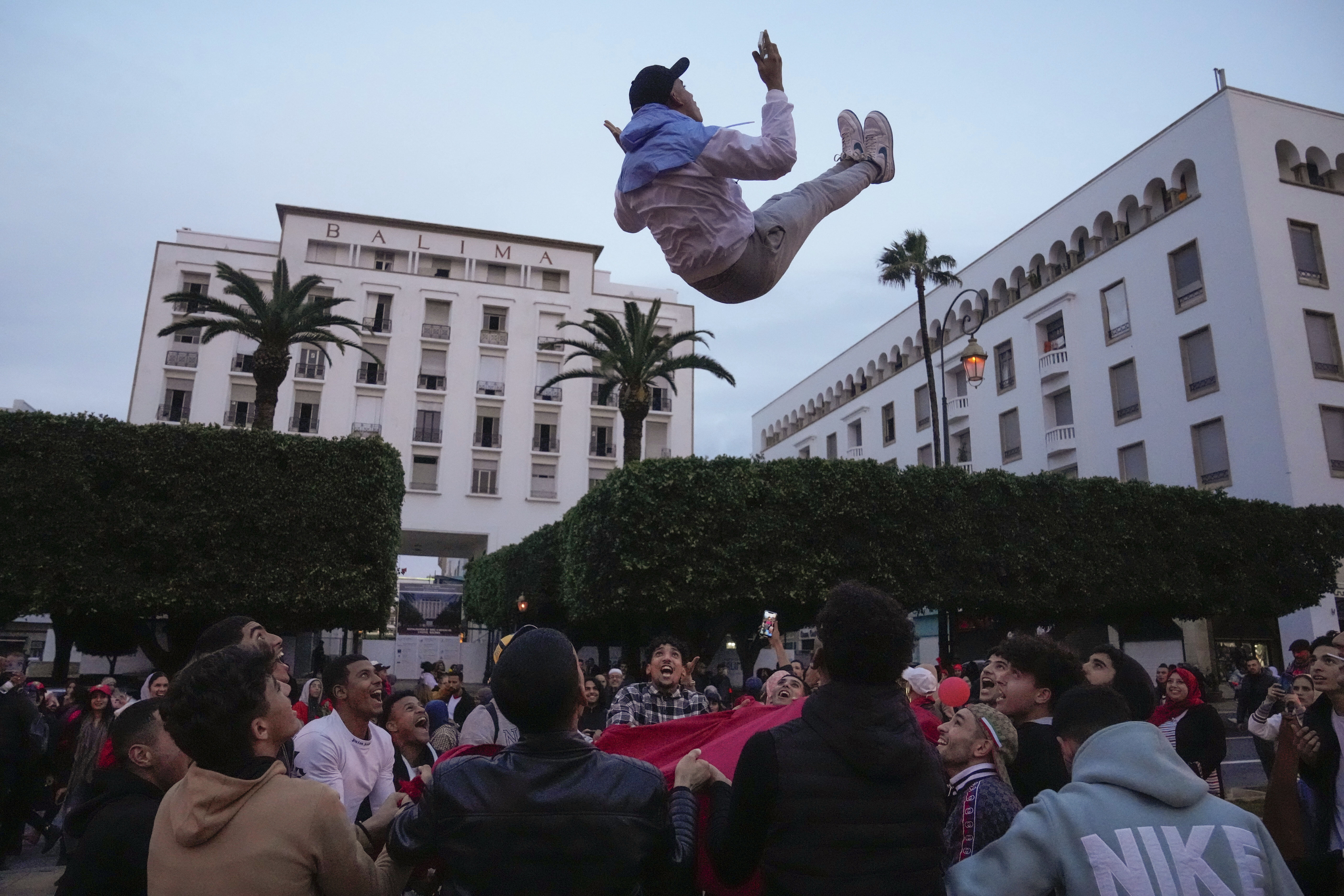 FILE - Moroccans celebrate in Rabat, Morocco, Saturday Dec. 10, 2022, after defeating Portugal in the quarterfinal soccer match of the World Cup played in Qatar. Morocco and its former colonizer France are facing off in the World Cup semifinal Wednesday, Dec. 14, 2022 in a historic match that has left both nations in the grip of excitement and anticipation — and fear of possible unrest.