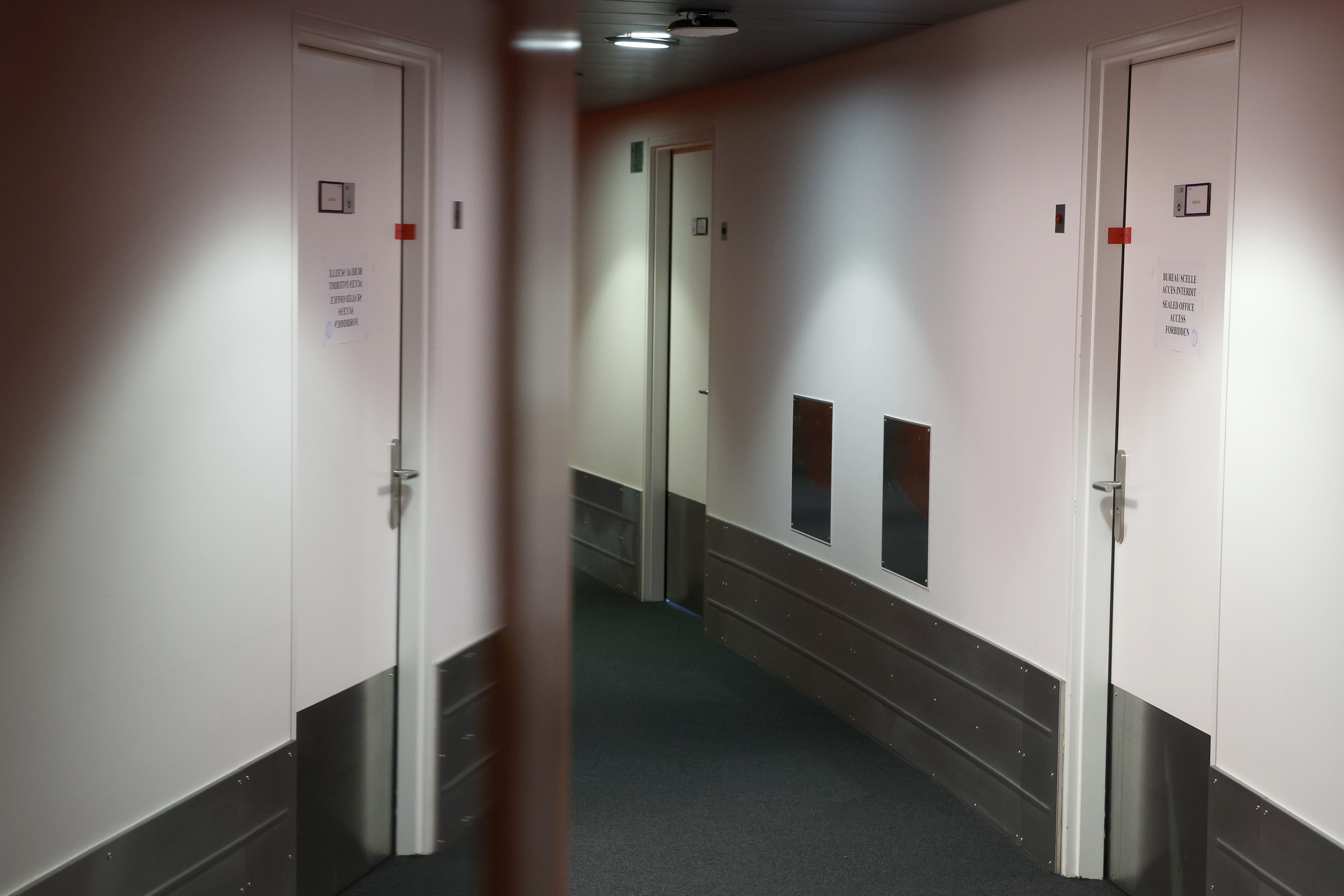 European Parliament Vice President Eva Kaili's office door, right, and which is sealed, is reflected in a mirror at the European Parliament in Strasbourg, eastern France, Tuesday Dec 13, 2022. The European Union's parliament was reeling Tuesday, it's credibility under threat, as a corruption and bribery scandal damaged lawmakers' careers and as fingers pointed at Qatari officials accused of seeking to play down labor rights concerns ahead of the soccer World Cup. 