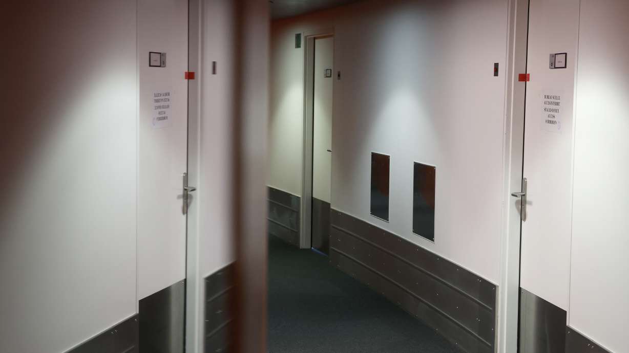 European Parliament Vice President Eva Kaili's office door, right, and which is sealed, is reflected in a mirror at the European Parliament in Strasbourg, eastern France, Tuesday Dec 13, 2022. The European Union's parliament was reeling Tuesday, it's credibility under threat, as a corruption and bribery scandal damaged lawmakers' careers and as fingers pointed at Qatari officials accused of seeking to play down labor rights concerns ahead of the soccer World Cup.