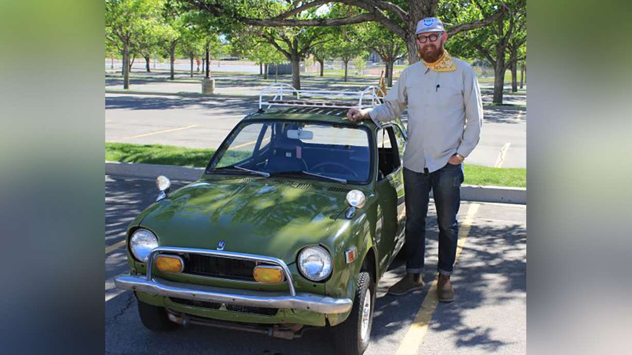 Quinn Peterson, of Provo, gives scale to his 1971 Honda Z600 at the UVU Auto Expo in 2022.