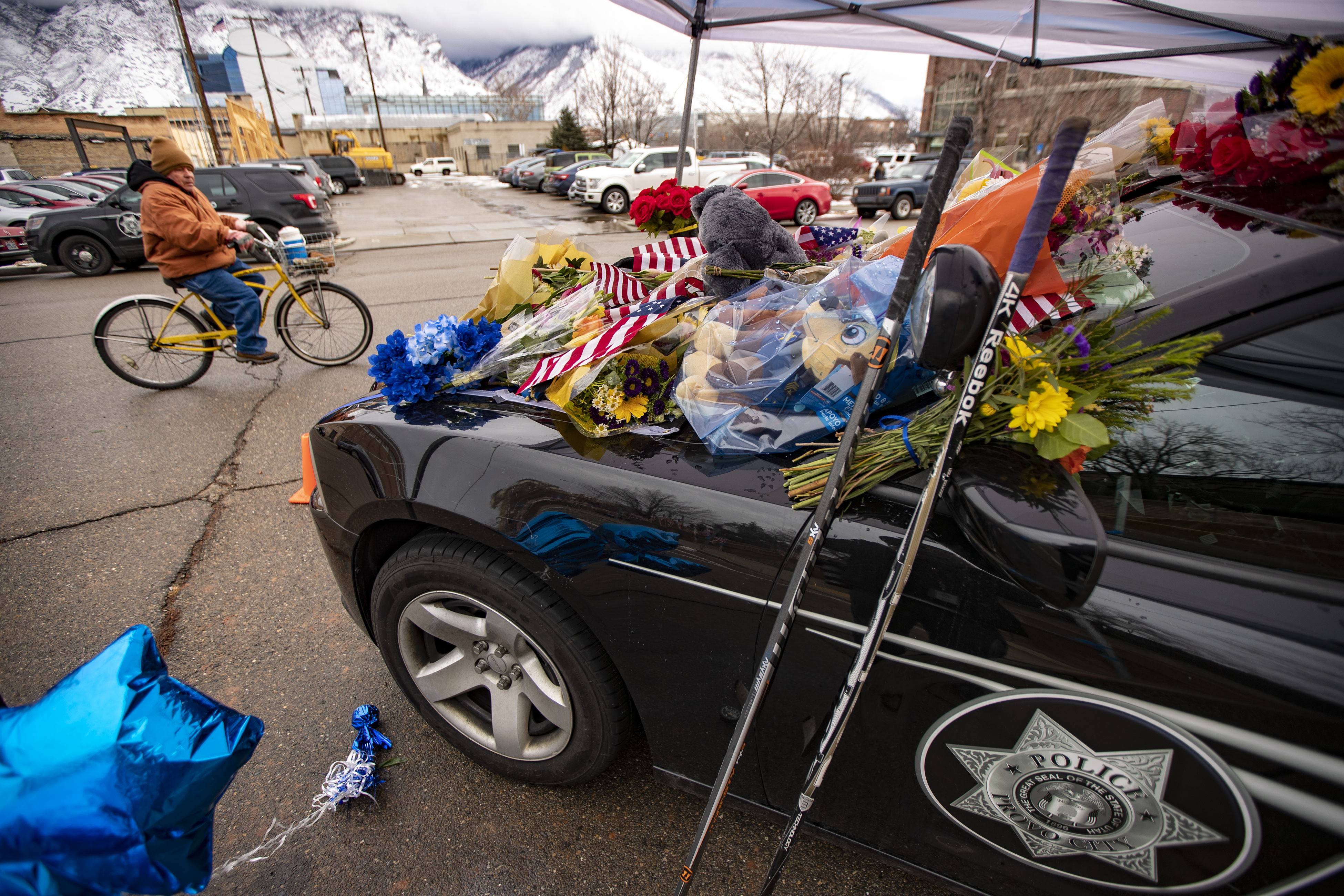 Flowers and other items cover slain Provo police officer Joseph Shinners' patrol car outside Provo Police Department's headquarters in Provo on Jan. 7, 2019. The trial for the man accused of shooting and killing Shinners was delayed on Wednesday.