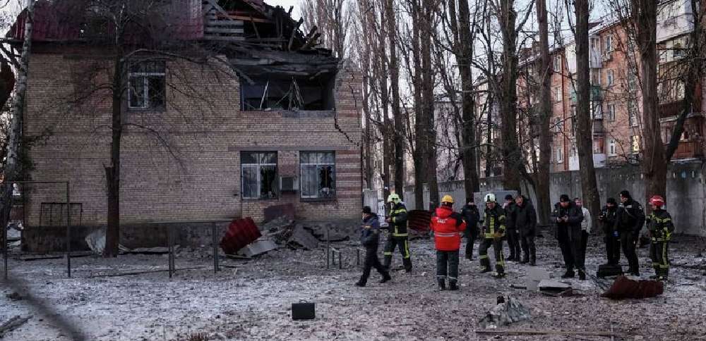 Rescuers and police officers examine parts of the drone at the site of a building destroyed by a Russian drone attack, as their attack on Ukraine continues, in Kyiv, Ukraine, Wednesday.