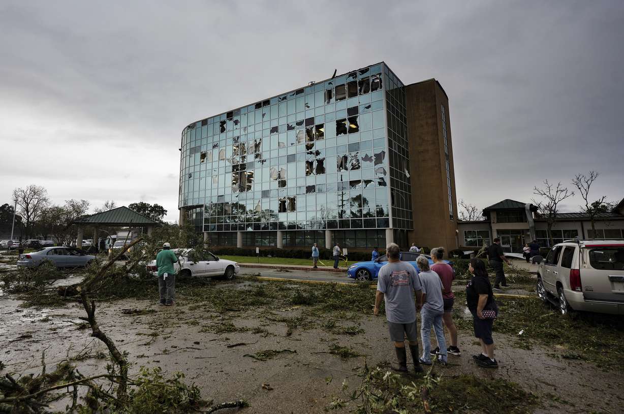 People survey damage following a tornado at the Iberia Medical Center, Wednesday, in New Iberia, La.