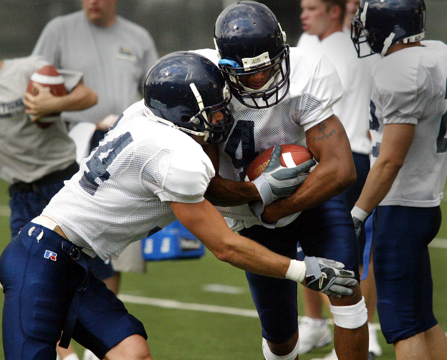 BYU corner backs Brandon Heaney, left, and Jernaro Gilford work through drills during practice, Aug. 11, 2003.