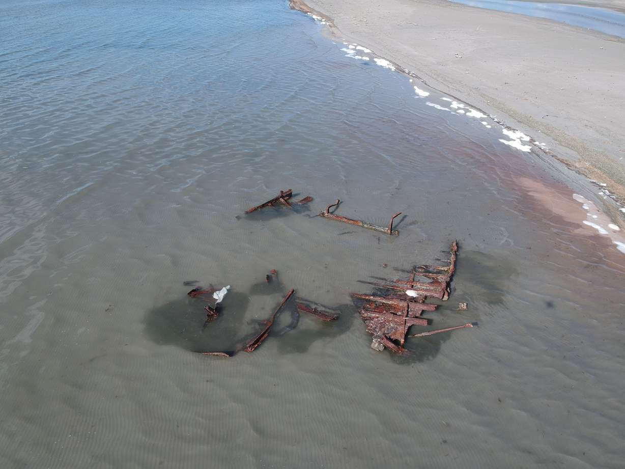 A shipwreck is visible in the Great Salt Lake after being uncovered by a storm in 2020. Low water levels have exposed once sunken ships, including this ship that was part of the Southern Pacific Railroad fleet used to help construct and maintain the Lucin Cutoff railroad trestle across the northern end of the lake.