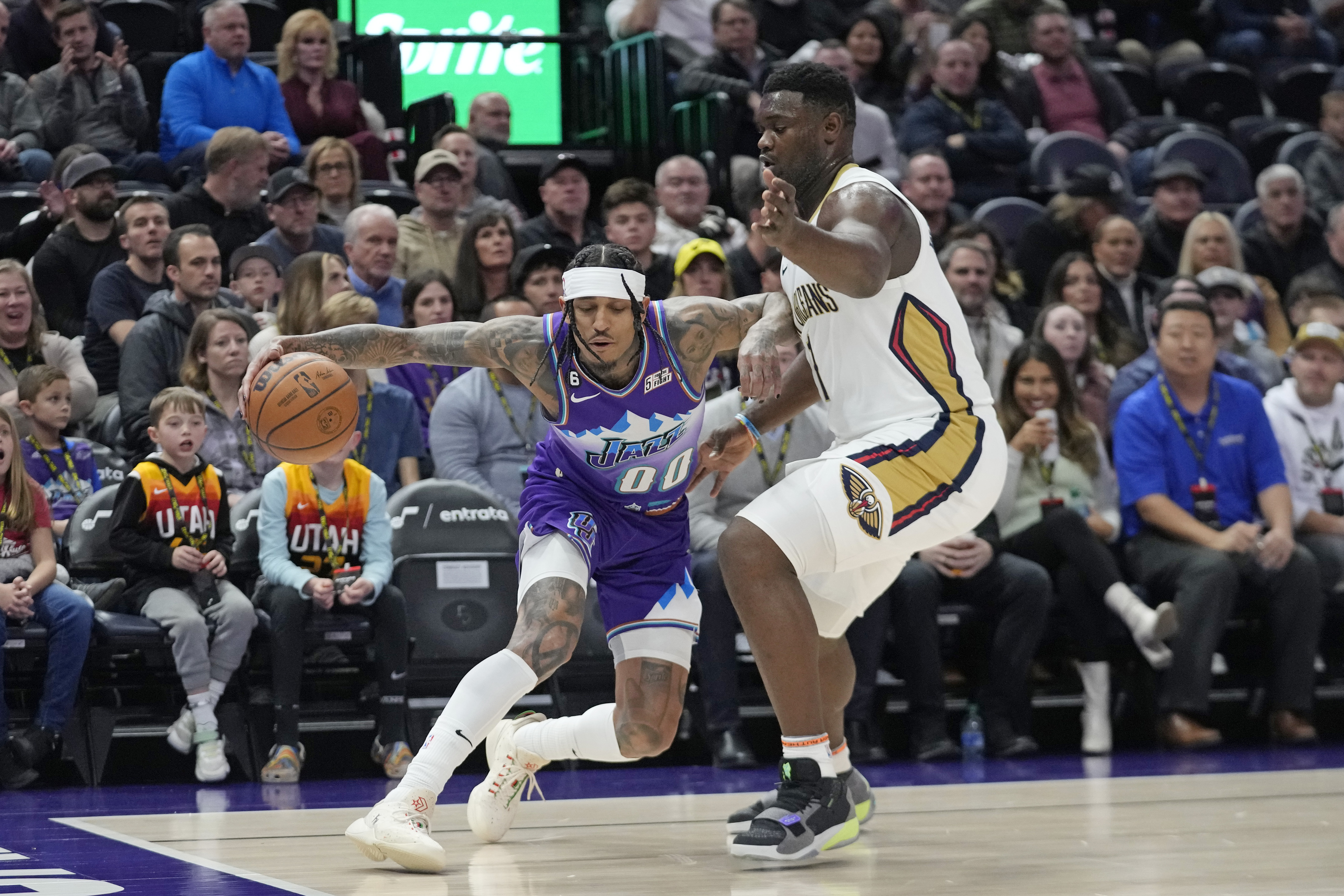 New Orleans Pelicans forward Zion Williamson (1) guards Utah Jazz guard Jordan Clarkson (00) during the first half of an NBA basketball game Thursday, Dec. 15, 2022, in Salt Lake City.