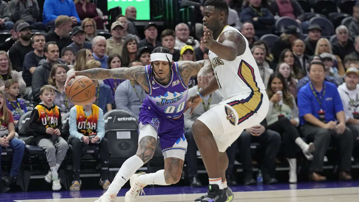 New Orleans Pelicans forward Zion Williamson (1) guards Utah Jazz guard Jordan Clarkson (00) during the first half of an NBA basketball game Thursday, Dec. 15, 2022, in Salt Lake City.