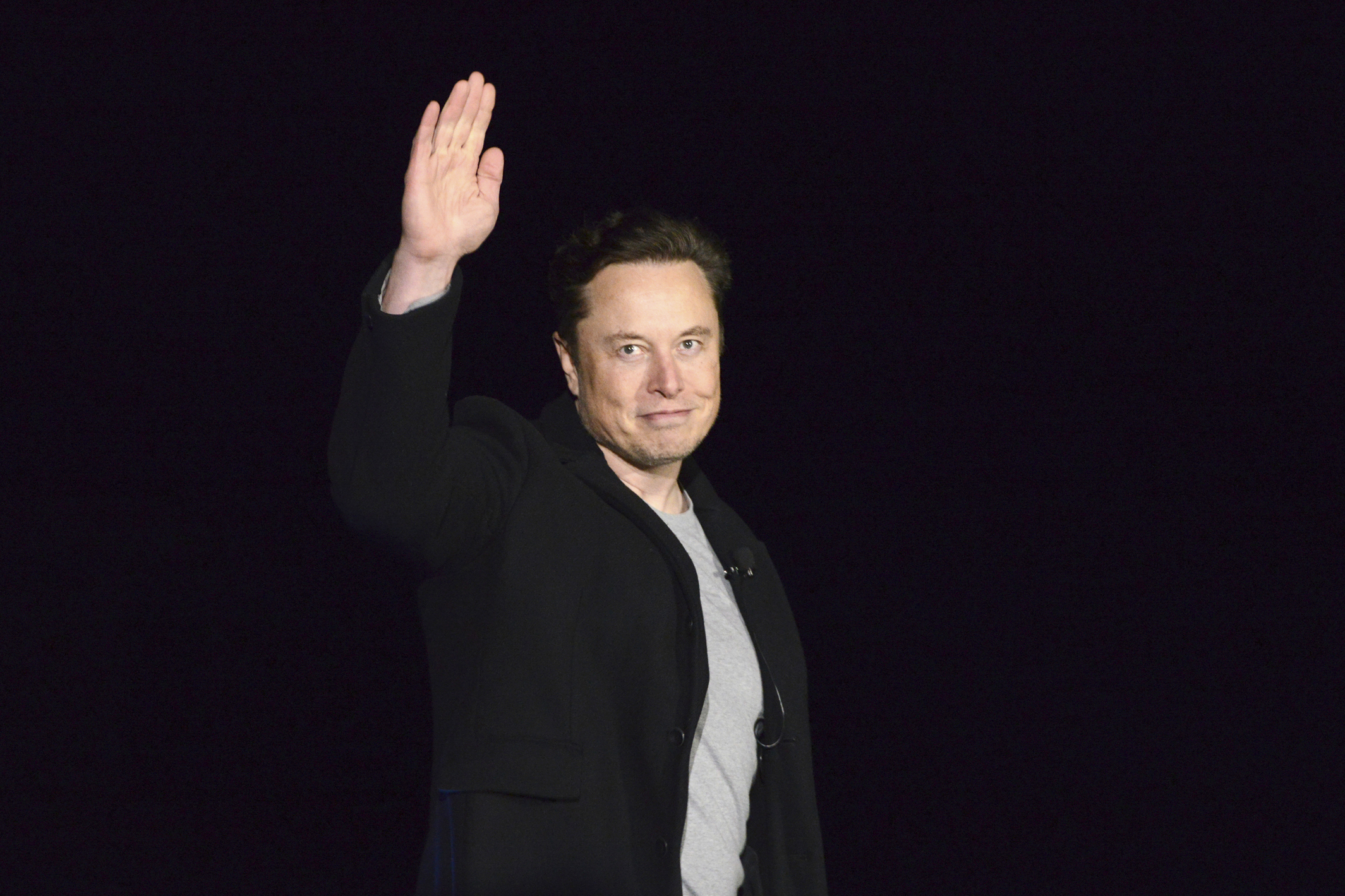 SpaceX's Elon Musk waves while providing an update on Starship, on Feb. 10, near Brownsville, Texas. Twitter on Thursday suspended the accounts of journalists who cover the social media platform and Musk.
