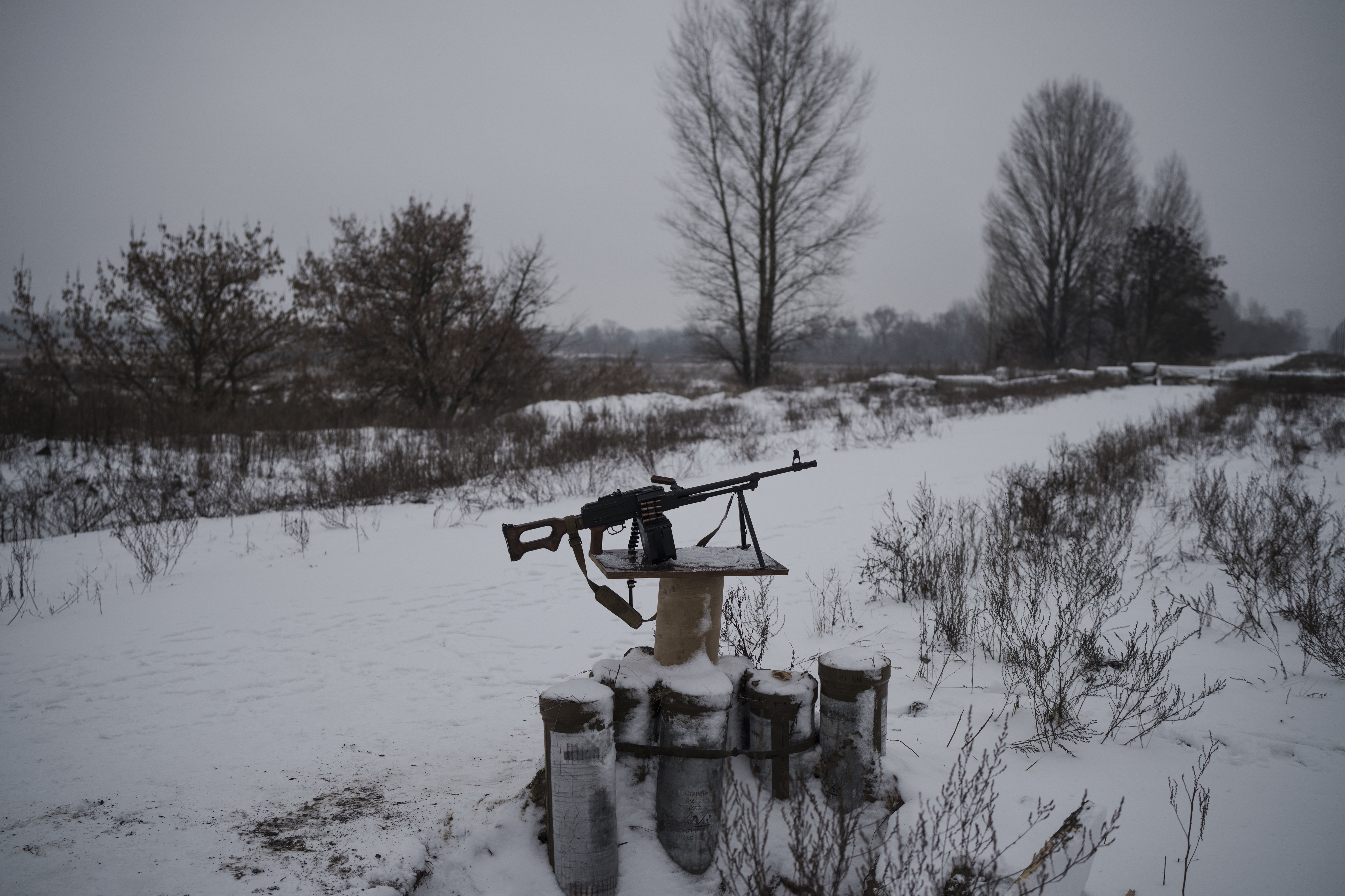 A machine gun sits on the side of a road after a Russian attack in Kyiv, Ukraine, Friday.