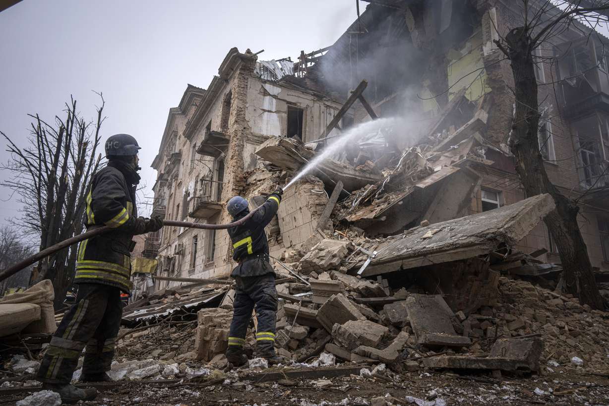 Ukrainian State Emergency Service firefighters work to extinguish a fire at the building which was destroyed by a Russian attack in Kryvyi Rih, Ukraine, Friday.