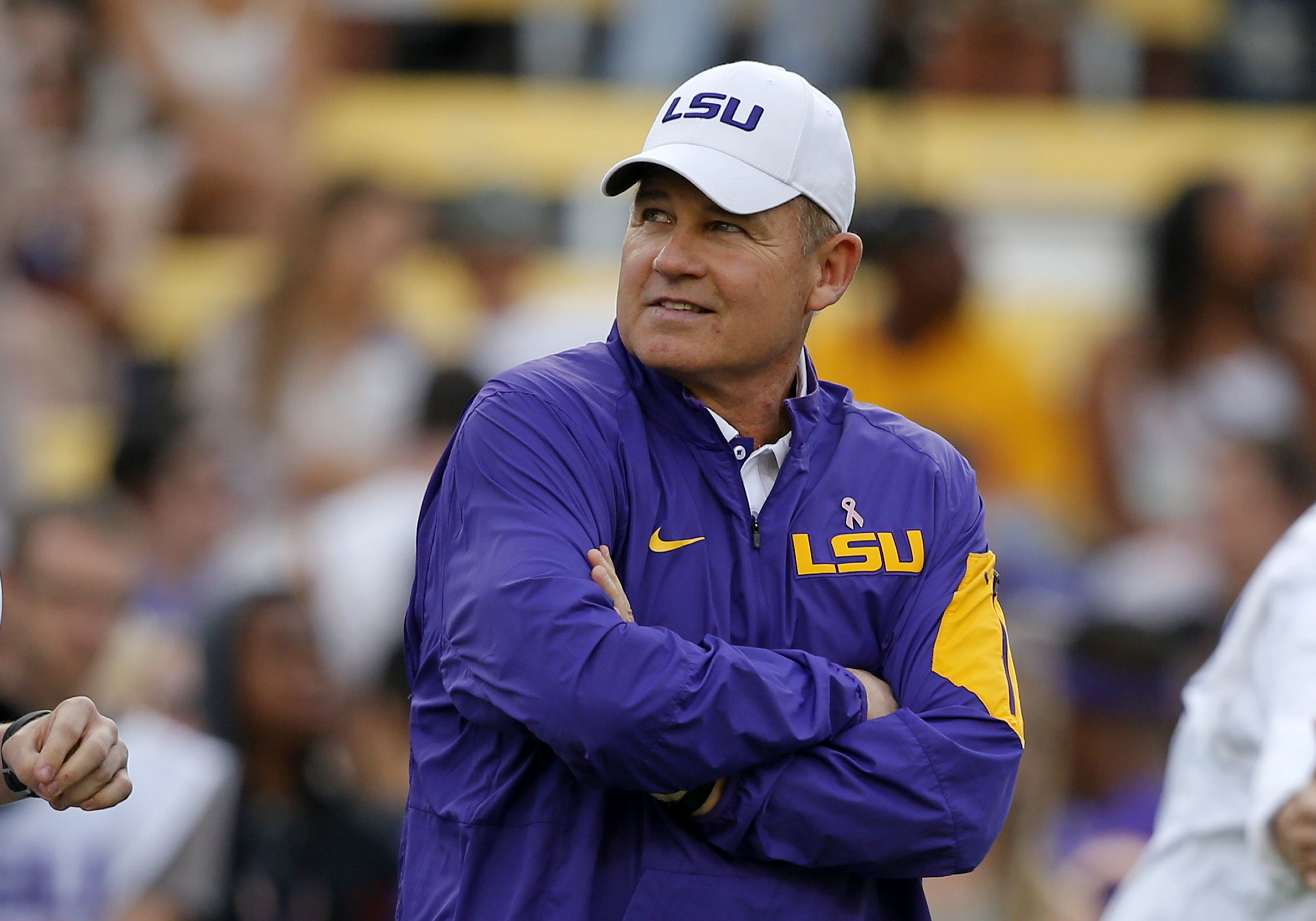 FILE - In this Oct. 17, 2015, file photo, LSU coach Les Miles watches his team warm up before an NCAA college football game against Florida in Baton Rouge, La. A former student who accused ex-LSU football coach Les Miles of sexual harassment in 2013 sought a $2.15 million settlement with LSU and Miles, according to documents filed in a former athletic department official's lawsuit. 