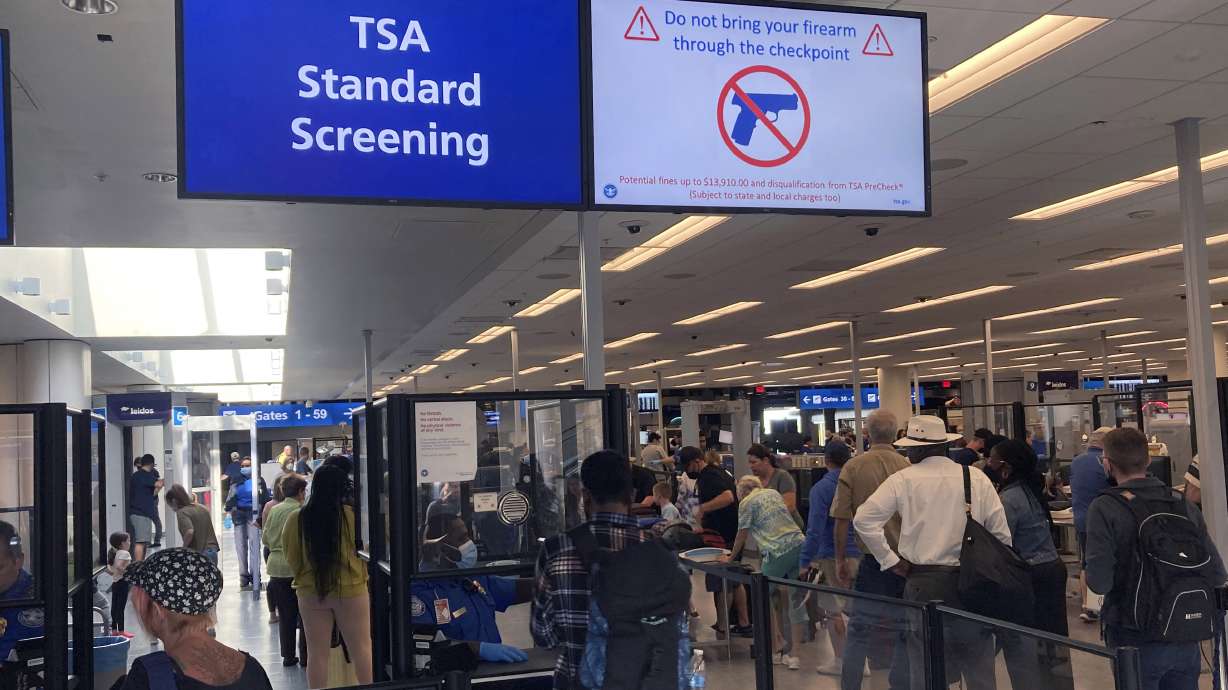 A sign warns travelers not to bring guns through the Transportation Security Administration checkpoint at Orlando International Airport in Orlando, Fla., on April 23. The TSA said Friday it is raising the fine for people caught with a gun in their carry-on bag to a maximum fine of $14,950 after intercepting a record number of firearms at security checkpoints this year. Previously it was $13,910.
