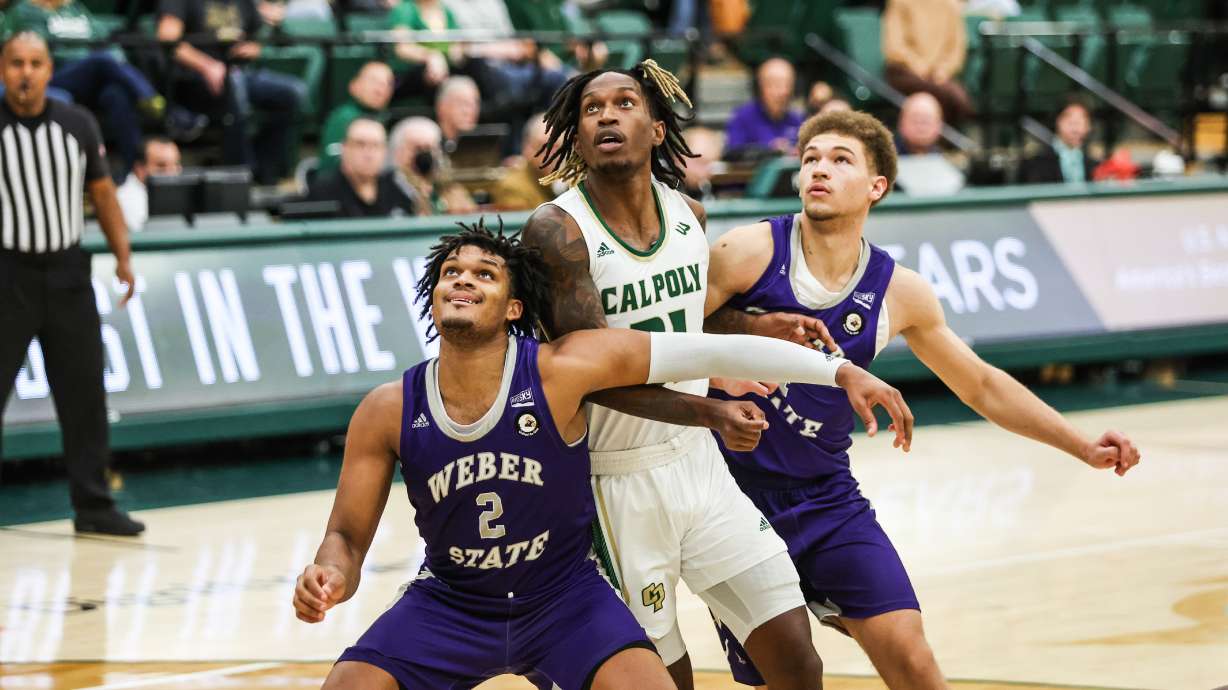 Weber State forwards Dillon Jones (2) and Dyson Koehler box out a Cal Poly player in a game the Wildcats won, 74-45, on Dec. 16, 2022.