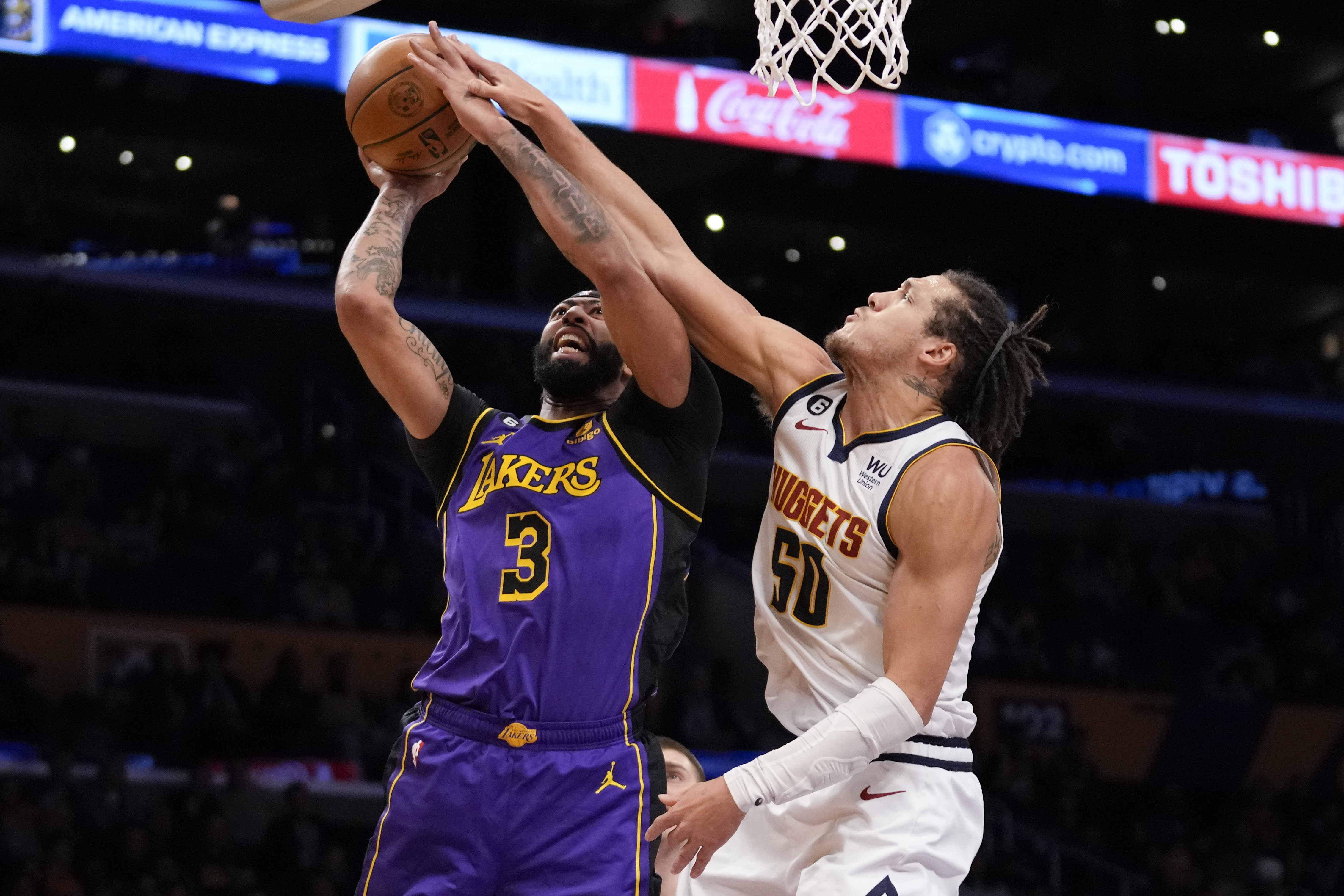 Los Angeles Lakers forward Anthony Davis (3) shoots against Denver Nuggets forward Aaron Gordon (50) during the first half of an NBA basketball game in Los Angeles, Friday, Dec. 16, 2022. 