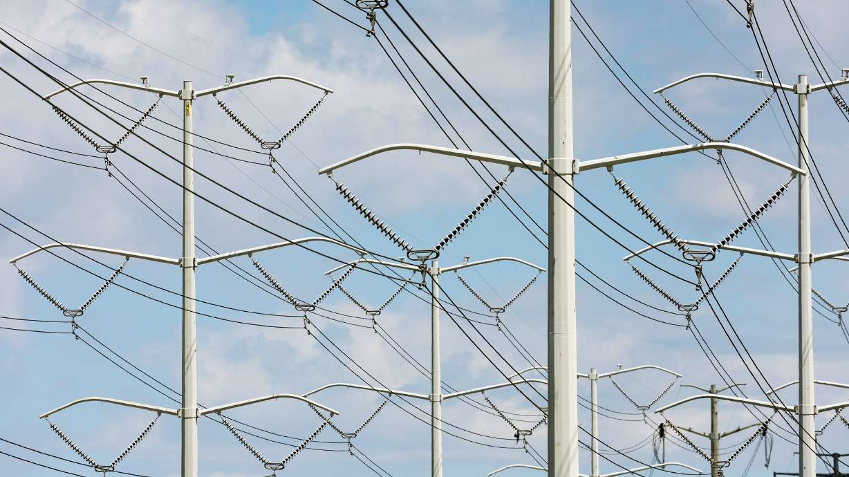 High-tension power lines run along Wright Brothers Drive on May 24, 2022.