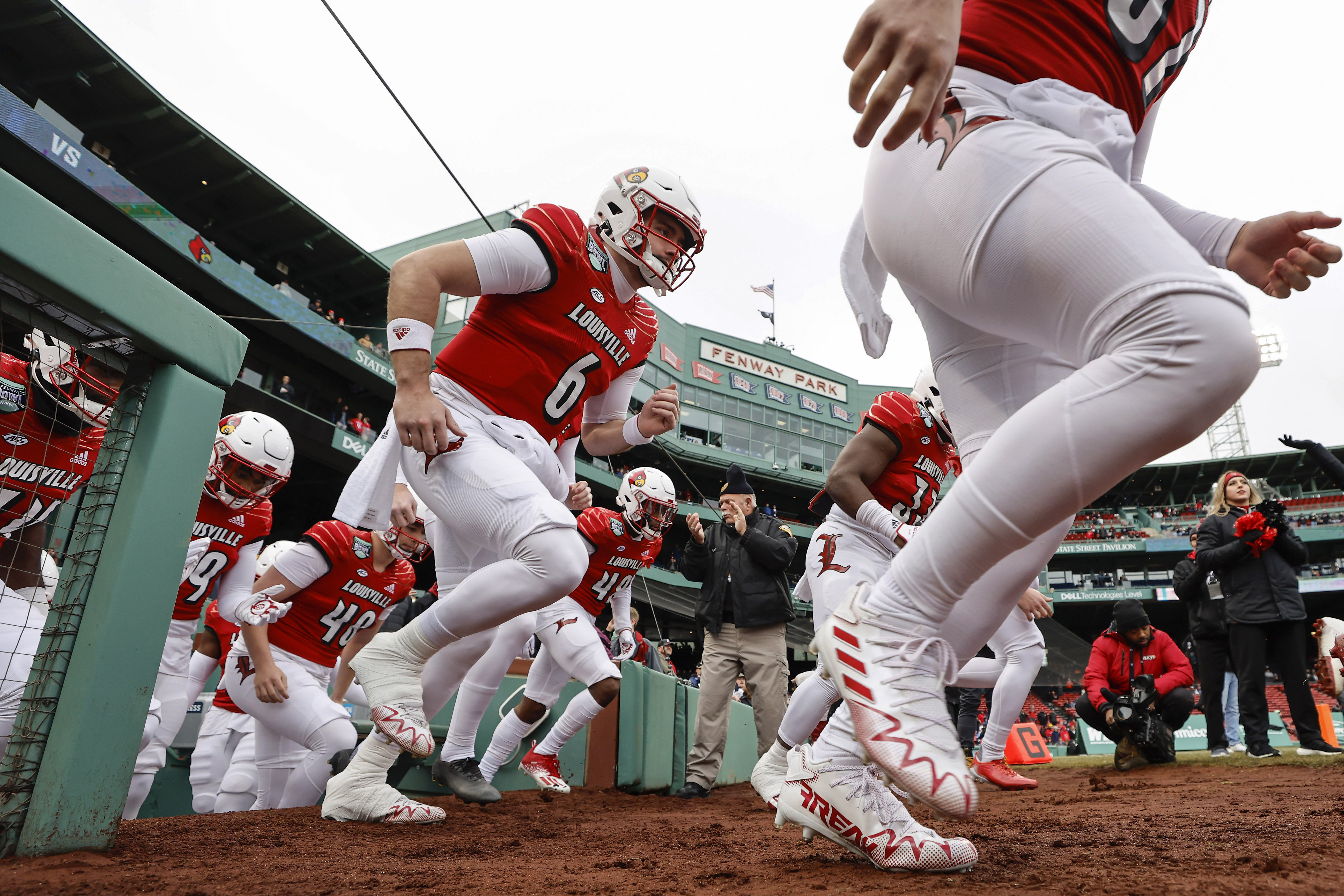 Louisville takes the field before the Fenway Bowl NCAA college football game against Cincinnati at Fenway Park, Saturday, Dec. 17, 2022, in Boston. 