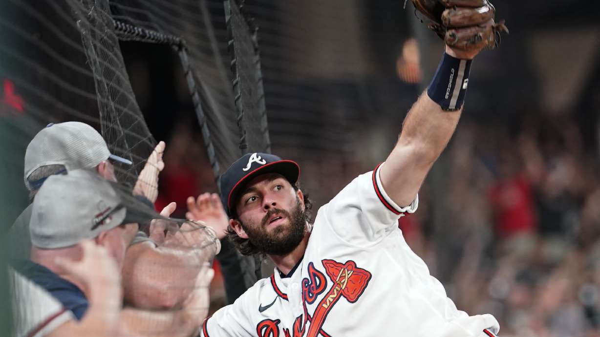 FILE - Atlanta Braves' Dansby Swanson (7) catches a ball hit by Philadelphia Phillies' Kyle Schwarber in the ninth inning of a baseball game Sept. 17, 2022, in Atlanta. The Chicago Cubs and Swanson agreed to a seven-year, $177 million contract on Saturday, Dec. 17, 2022, adding the All-Star shortstop to their rebuilding project. The deal includes a full no-trade clause, according to a person familiar with the negotiations who spoke to the AP on condition of anonymity because the contract was pending a physical.