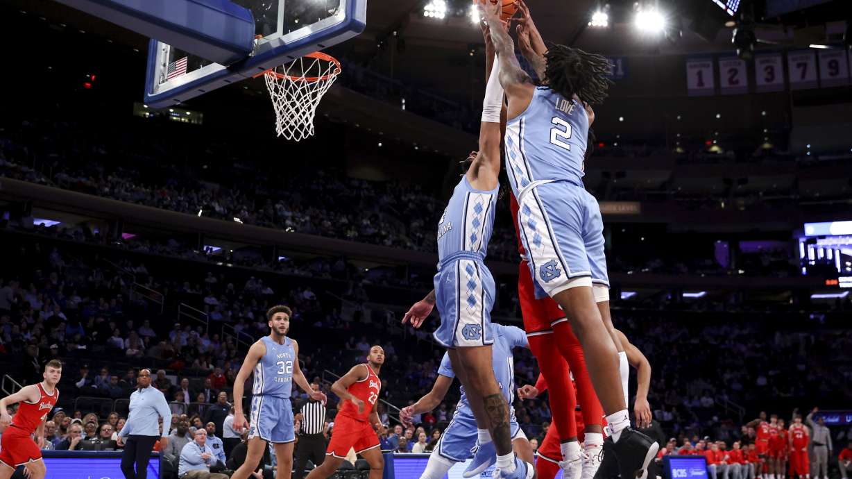 North Carolina guard Caleb Love (2) grabs the ball during the first half of an NCAA college basketball game against Ohio State in the CBS Sports Classic, Saturday, Dec. 17, 2022, in New York.