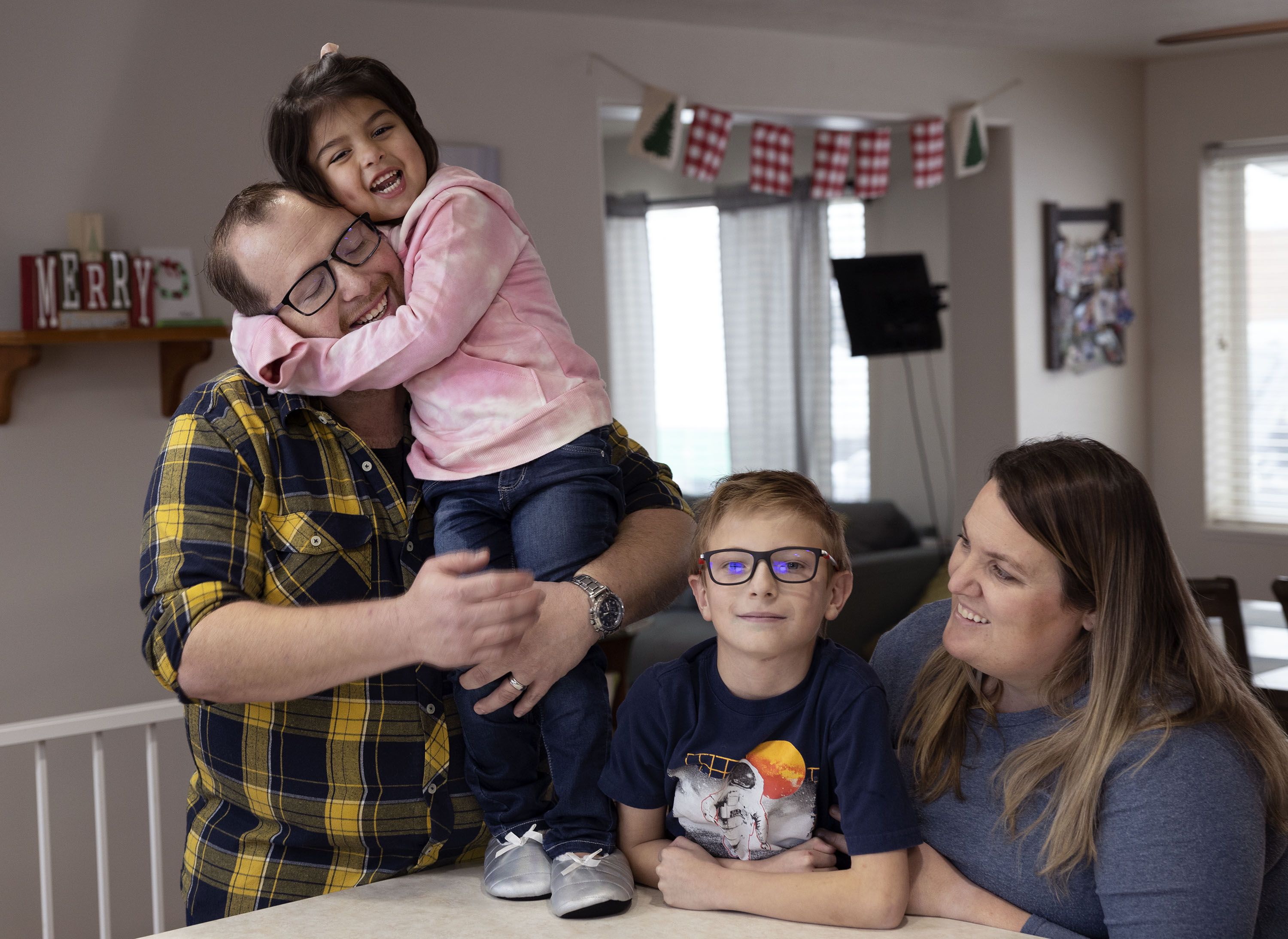 Matthew, Madison, Miles and Amanda McKnight are photographed in their Sandy home on Friday.