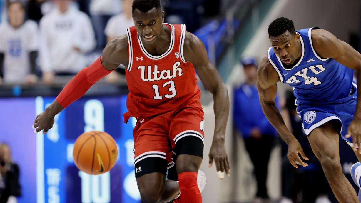 Utah Utes center Keba Keita (13) eyes the ball after knocking it away from Brigham Young Cougars forward Atiki Ally Atiki (4) as BYU and Utah play at the Marriott Center in Provo on Saturday, Dec. 17, 2022.