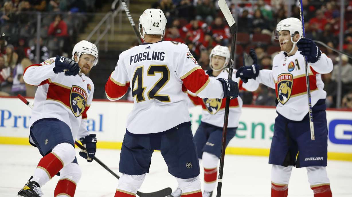 Florida Panthers defenseman Gustav Forsling (42) celebrates with teammates after scoring a goal against the New Jersey Devils during the second period of an NHL hockey game, Saturday Dec. 17, 2022, in Newark, N.J.