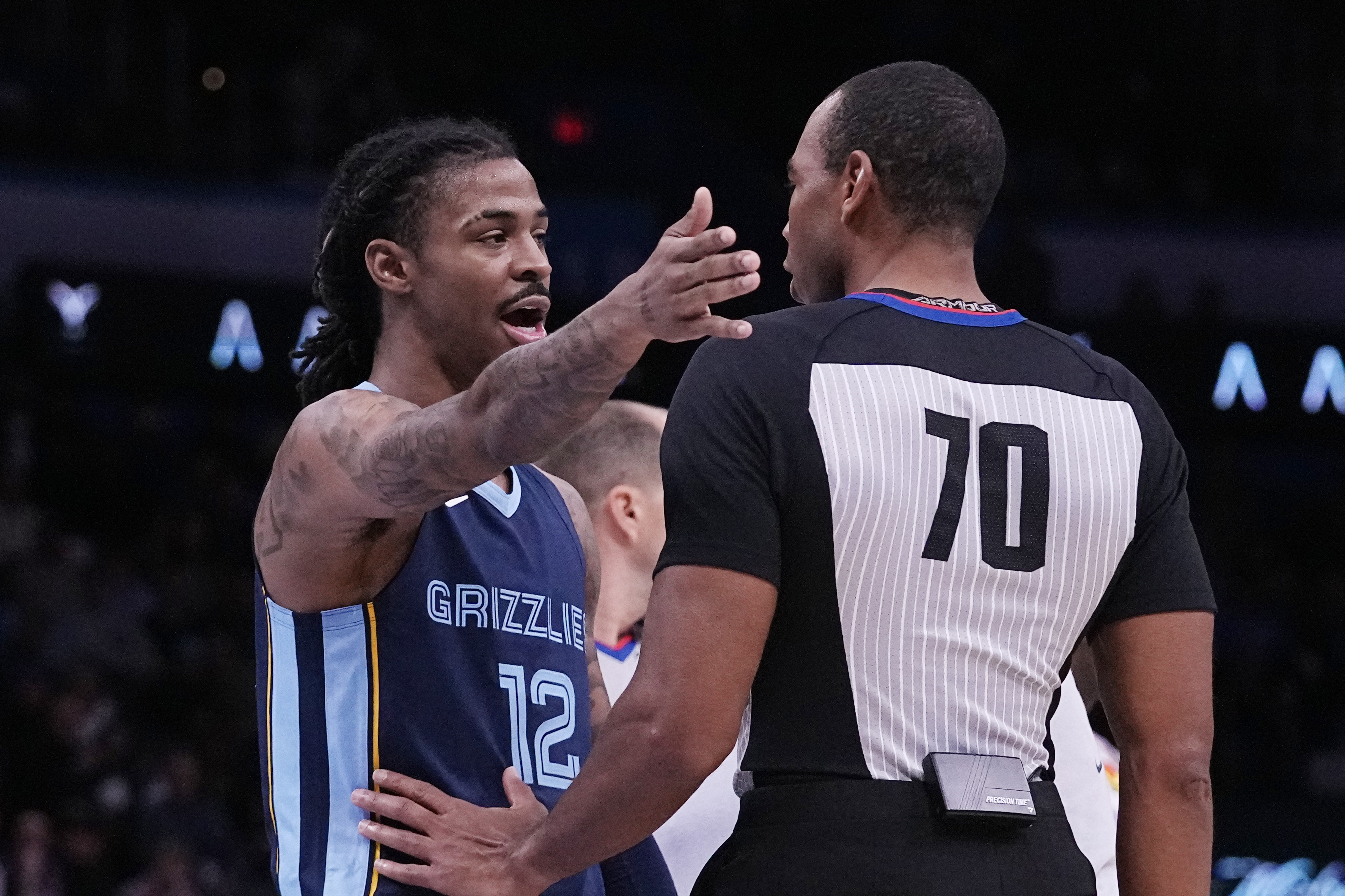Memphis Grizzlies guard Ja Morant (12) talks to referee Phenizee Ransom, right, after receiving a technical foul in the first half of an NBA basketball game against the Oklahoma City Thunder, Saturday, Dec. 17, 2022, in Oklahoma City. 