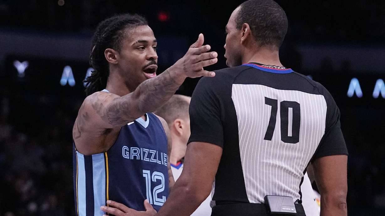 Memphis Grizzlies guard Ja Morant (12) talks to referee Phenizee Ransom, right, after receiving a technical foul in the first half of an NBA basketball game against the Oklahoma City Thunder, Saturday, Dec. 17, 2022, in Oklahoma City.