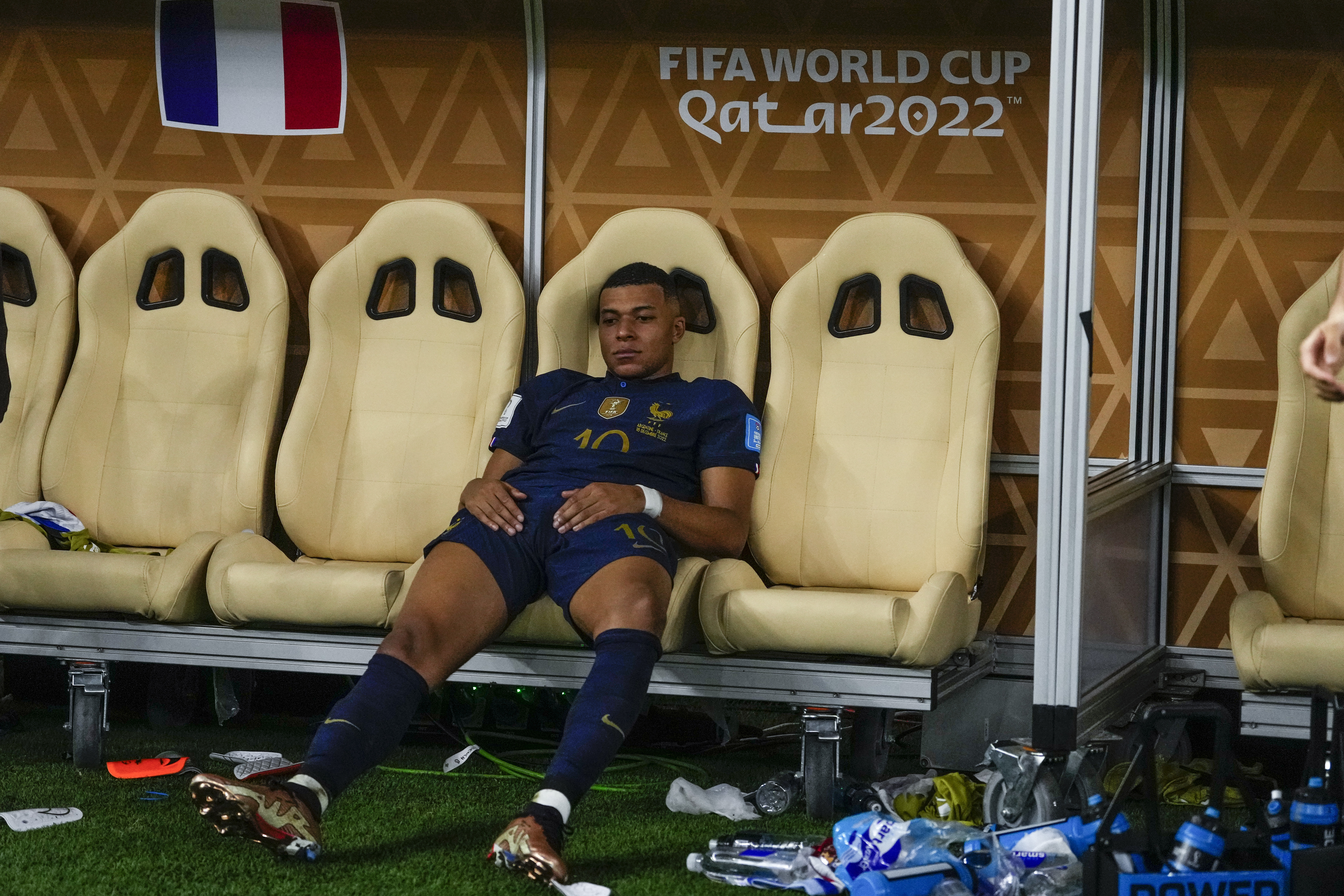 France's Kylian Mbappe sits on the bench at the end of the World Cup final soccer match between Argentina and France at the Lusail Stadium in Lusail, Qatar, Sunday, Dec.18, 2022. 