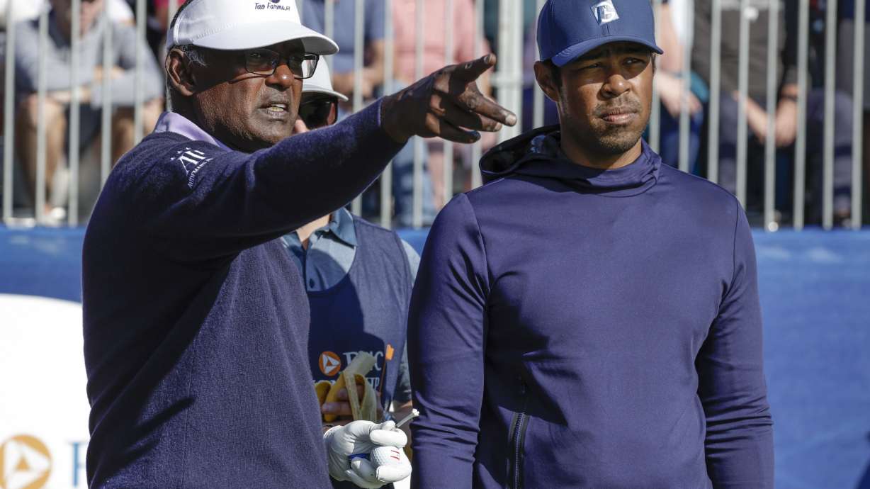 Vijay Singh, right, and his son Qass Sing, left, talk before teeing off the first hole during the first round of the PNC Championship golf tournament Saturday, Dec. 17, 2022, in Orlando, Fla.