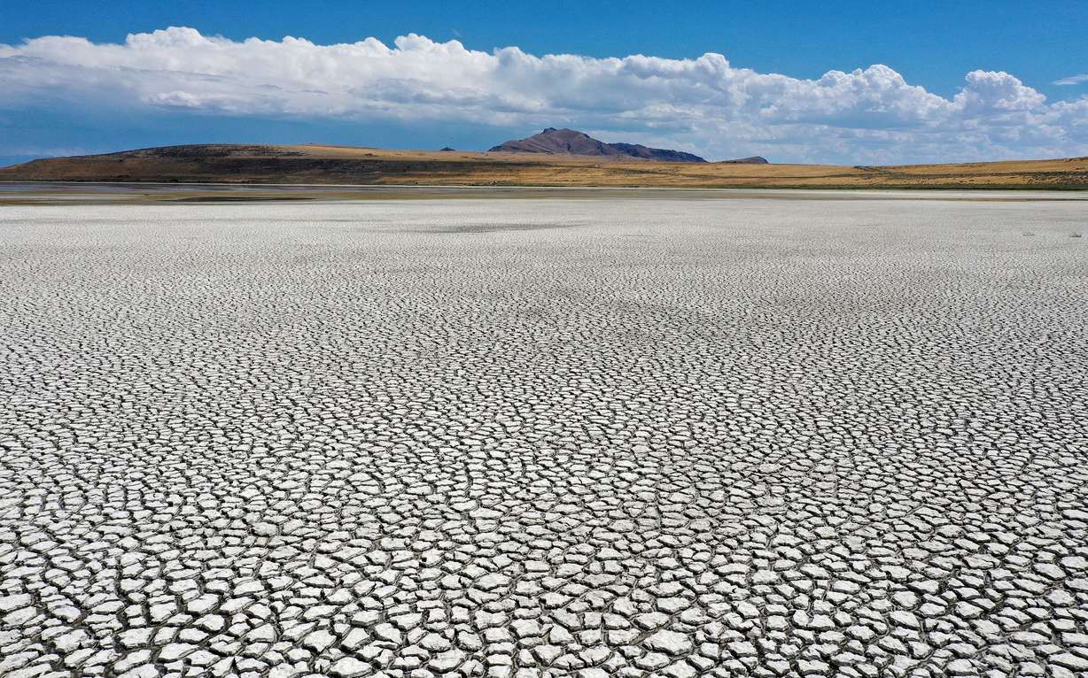 Dried lake bed is pictured in Farmington Bay, looking at Antelope Island, as the Great Salt Lake experiences record low water levels on July 22.