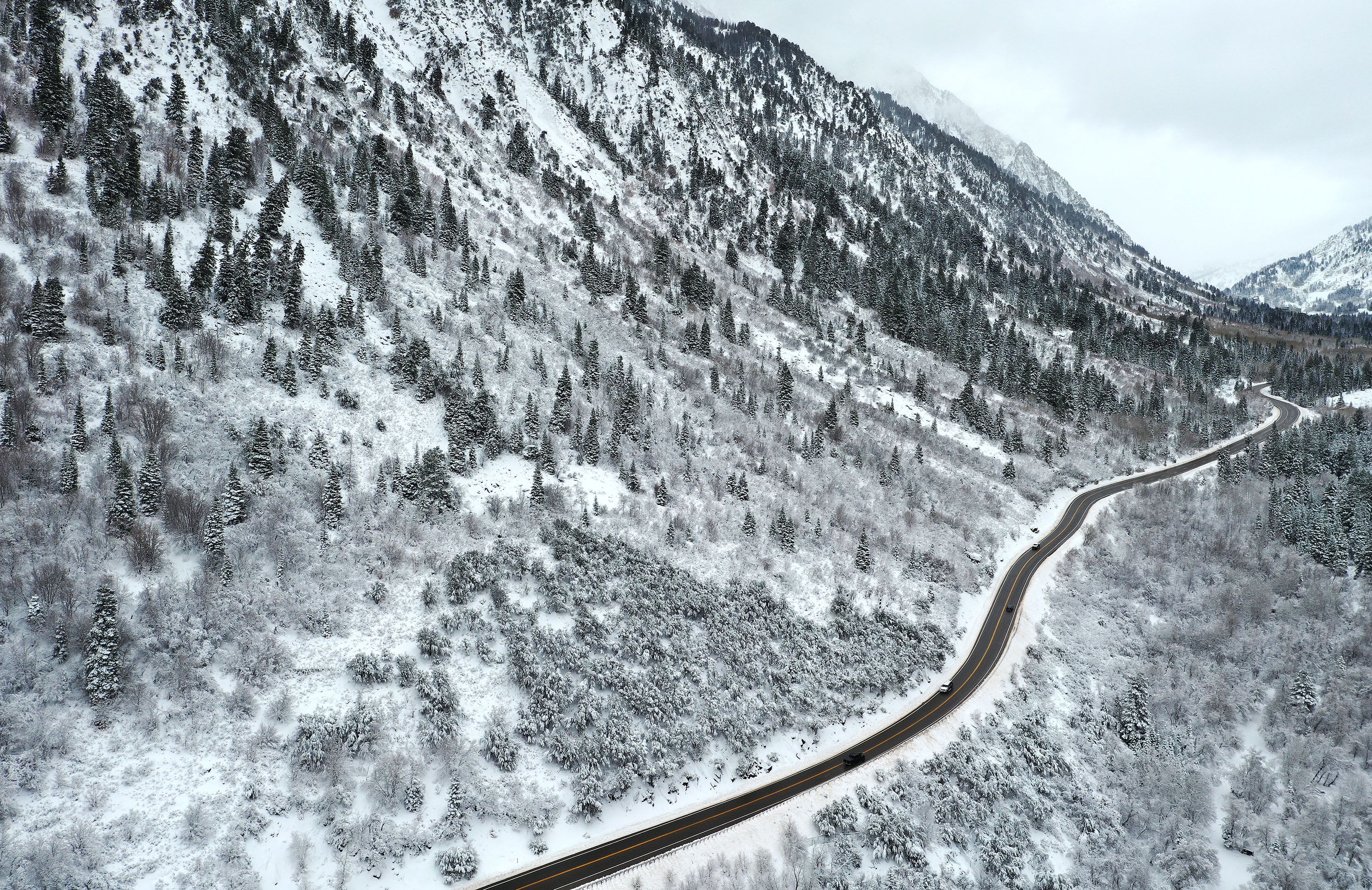 Motorists drive through the snow-covered landscape in Little Cottonwood Canyon on Nov. 9.