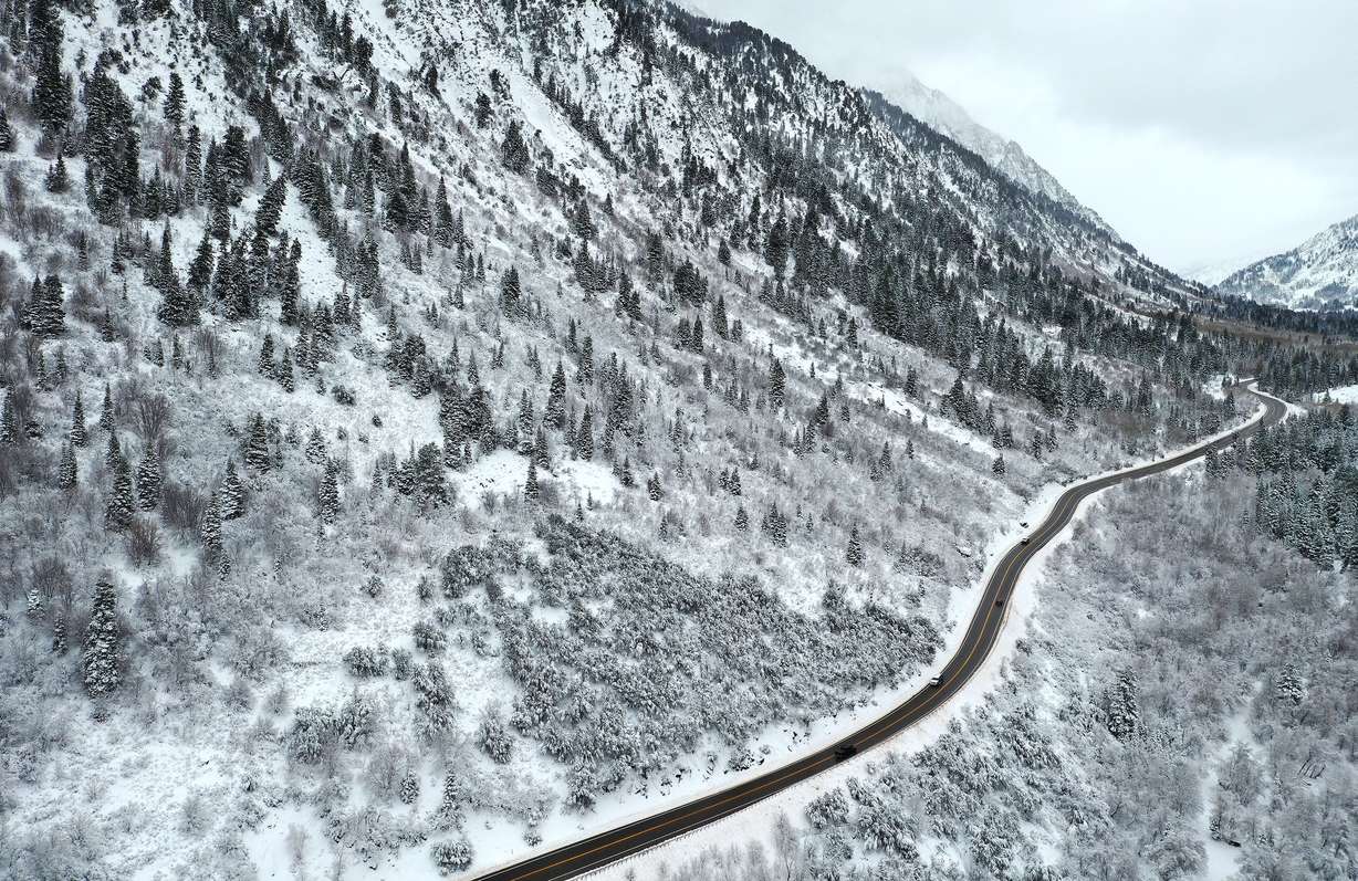 Motorists drive through the snow-covered landscape in Little Cottonwood Canyon on Nov. 9.