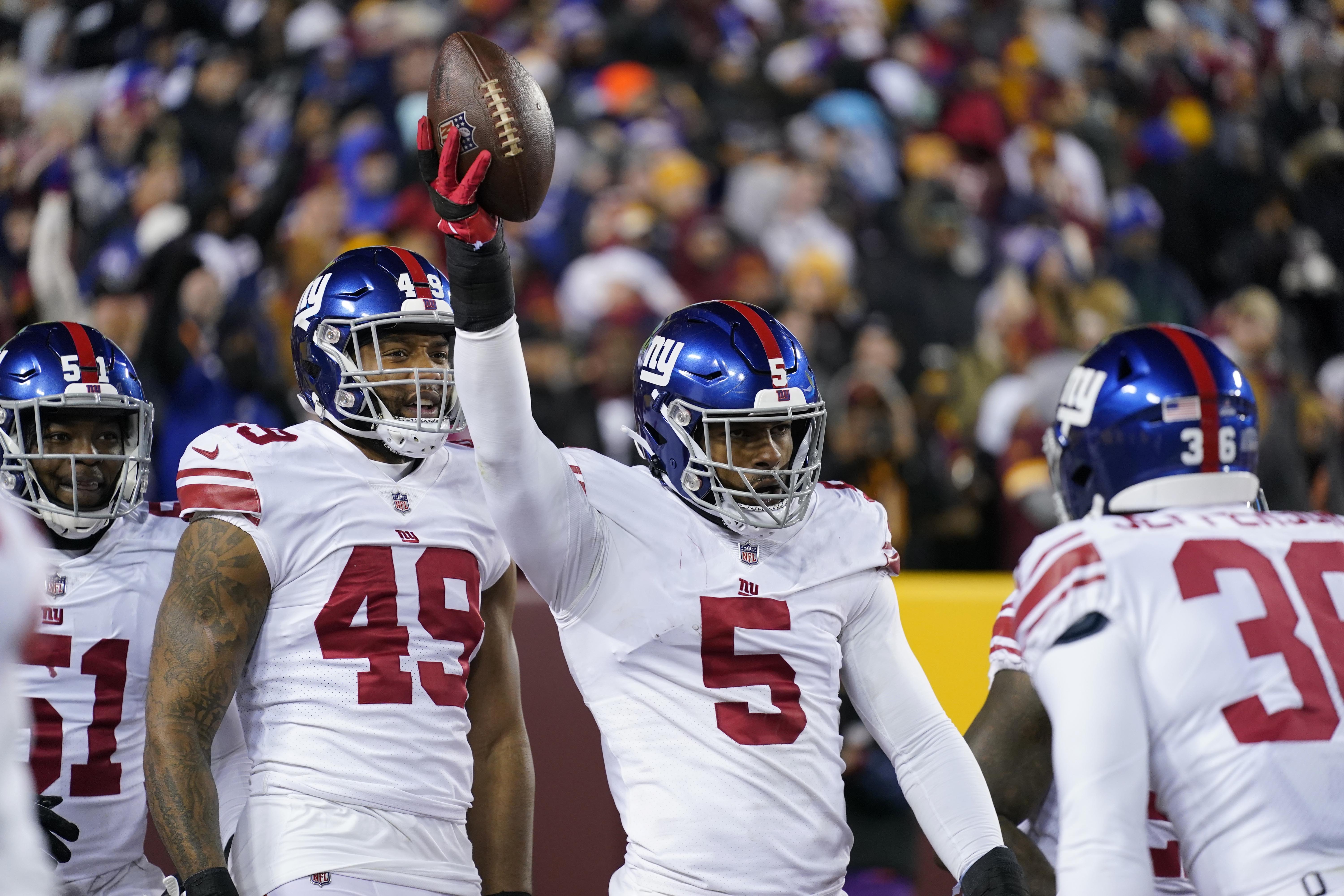 New York Giants defensive end Kayvon Thibodeaux (5) celebrates after scoring a touchdown during the first half of an NFL football game against the Washington Commanders, Sunday, Dec. 18, 2022, in Landover, Md. 