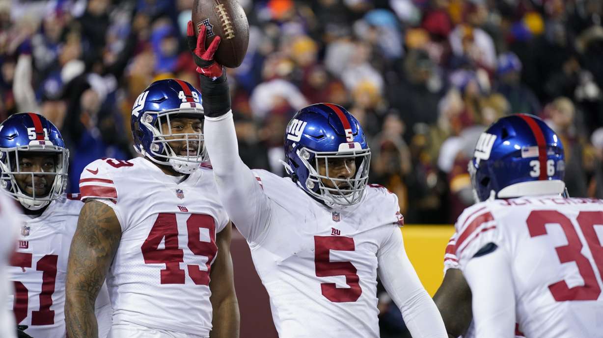 New York Giants defensive end Kayvon Thibodeaux (5) celebrates after scoring a touchdown during the first half of an NFL football game against the Washington Commanders, Sunday, Dec. 18, 2022, in Landover, Md.