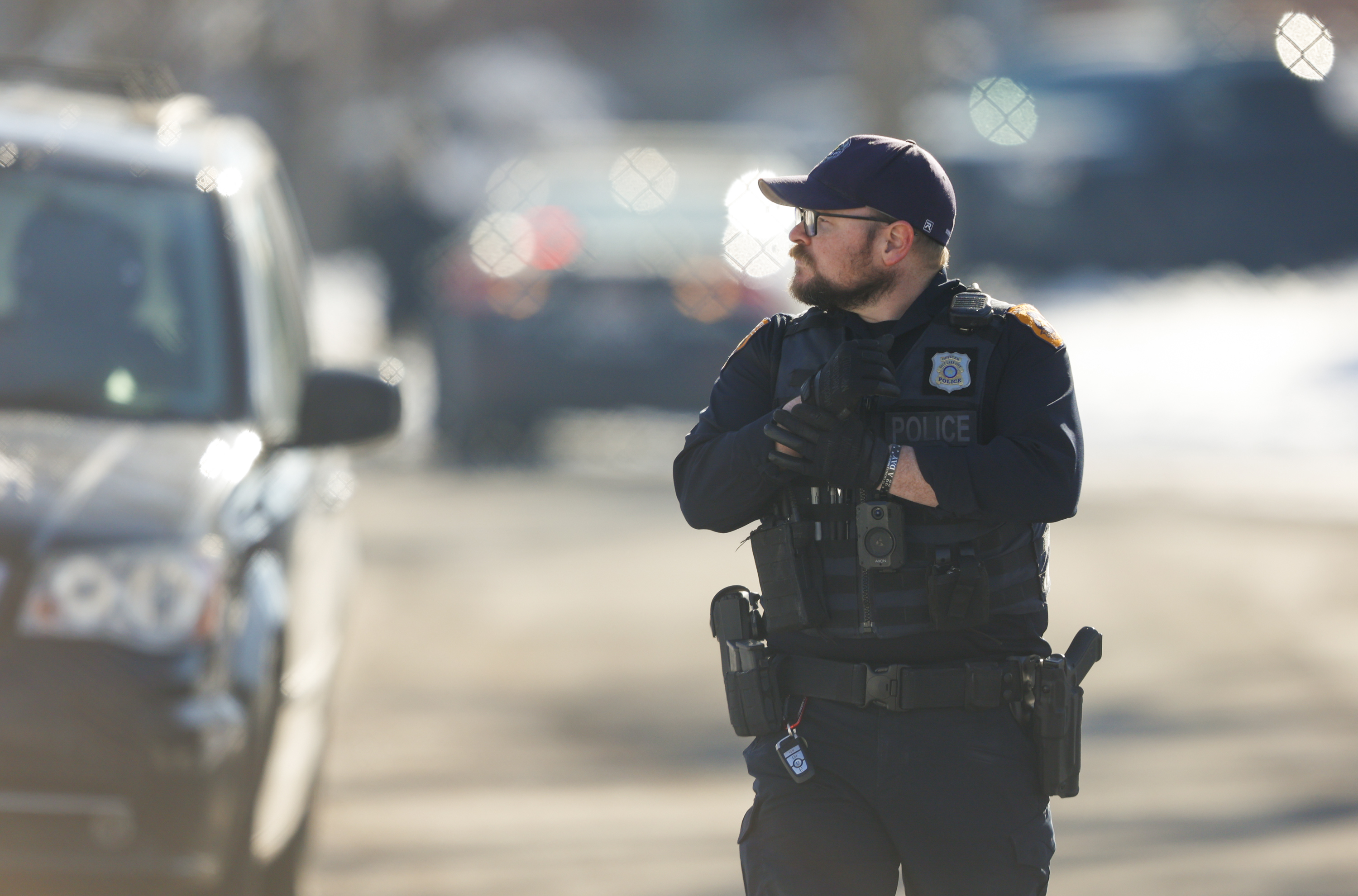 An officer walks down a street during a manhunt in Salt Lake City on Sunday. Angel Tinajero, 22, was arrested after firing shots and hiding for hours in an elderly woman's home he had broken into, police say.